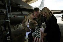 Lt.Col. William Bailey, 4th Fighter Squadron commander, greets his wife Monica and children Cori, Nate and Erin upon his arrival to Hill Air Force Base, Utah, Friday. Colonel Bailey and his team of six F-16s are the first to arrive home from a nearly seven month deployment at Bagram Airfield, Afghanistan. (U.S. Air Force photo/Staff Sgt. Renae Saylock)