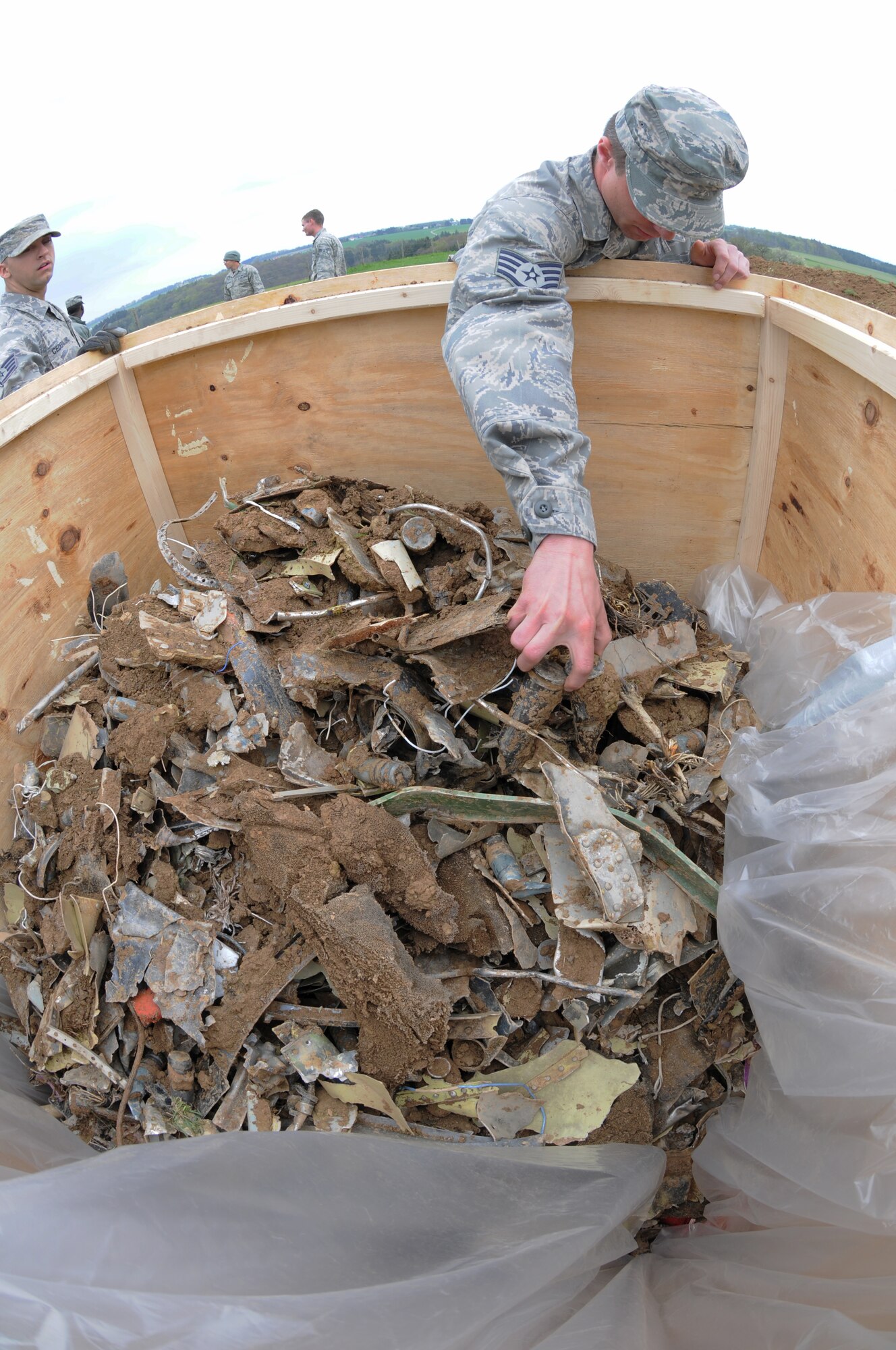 SPANGDAHLEM AIR BASE, Germany – Staff Sgt. Adam Combs, 52nd Equipment Maintenance Squadron tactical aircraft maintenance craftsman, places debris into a crate to be removed from the crash site of an Air Force A-10 Thunderbolt II near Laufeld, Germany, April 14. The aircraft crashed April 1 in a field outside Laufeld, a town north of the city of Wittlich. The pilot, Lt. Col. Scott Hurrelbrink, 81st Fighter Squadron, here was treated for injuries at the krankenhaus der Barmherzigen Bruder, and no one else was injured due to the mishap. (U.S. Air Force photo/Airman 1st Class Matthew B. Fredericks)