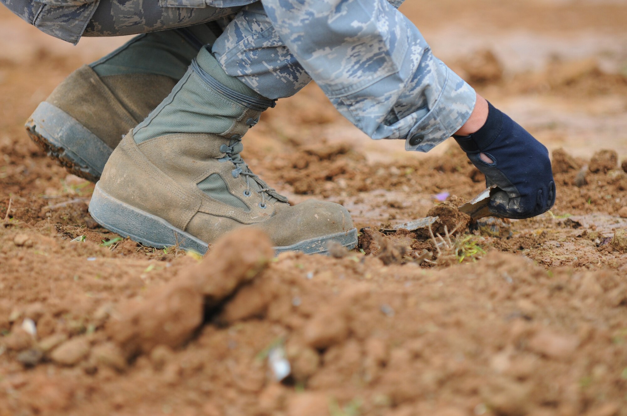 SPANGDAHLEM AIR BASE, Germany – A 52nd Civil Engineer Squadron Airman clears debris from the crash site of an Air Force A-10 Thunderbolt II near Laufeld, Germany, April 14. The aircraft crashed April 1 in a field outside Laufeld, a town north of the city of Wittlich. The pilot, Lt. Col. Scott Hurrelbrink, 81st Fighter Squadron, here was treated for injuries at the Krankenhaus der Barmherzigen Bruder, and no one else was injured in the mishap.  The Safety Investigation Board is continuing its investigation into the cause of the crash. (U.S. Air Force photo/Airman 1st Class Matthew B. Fredericks)