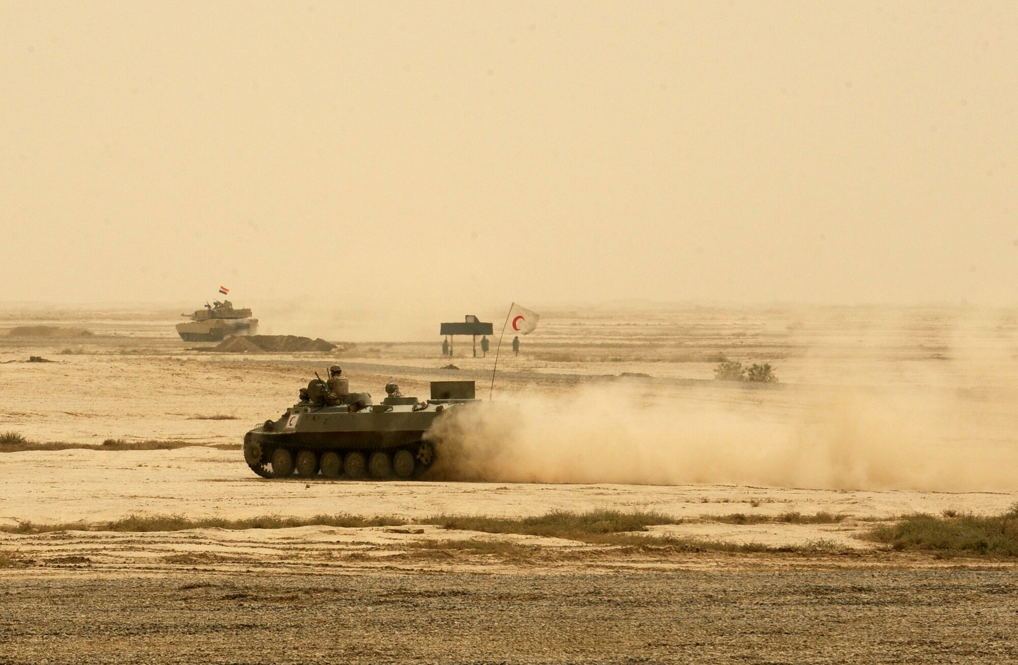 BESMAYA RANGE COMPLEX, Iraq - An Iraqi armored personnel carrier heads into the action to pick up simulated casualties during a joint demonstration near Baghdad April 18. As the U.S. end of mission scheduled for December draws closer, American advisors are taking a step back to allow Iraqi forces to demonstrate their capabilities. (U.S. Air Force photo by Tech. Sgt. Randy Redman)