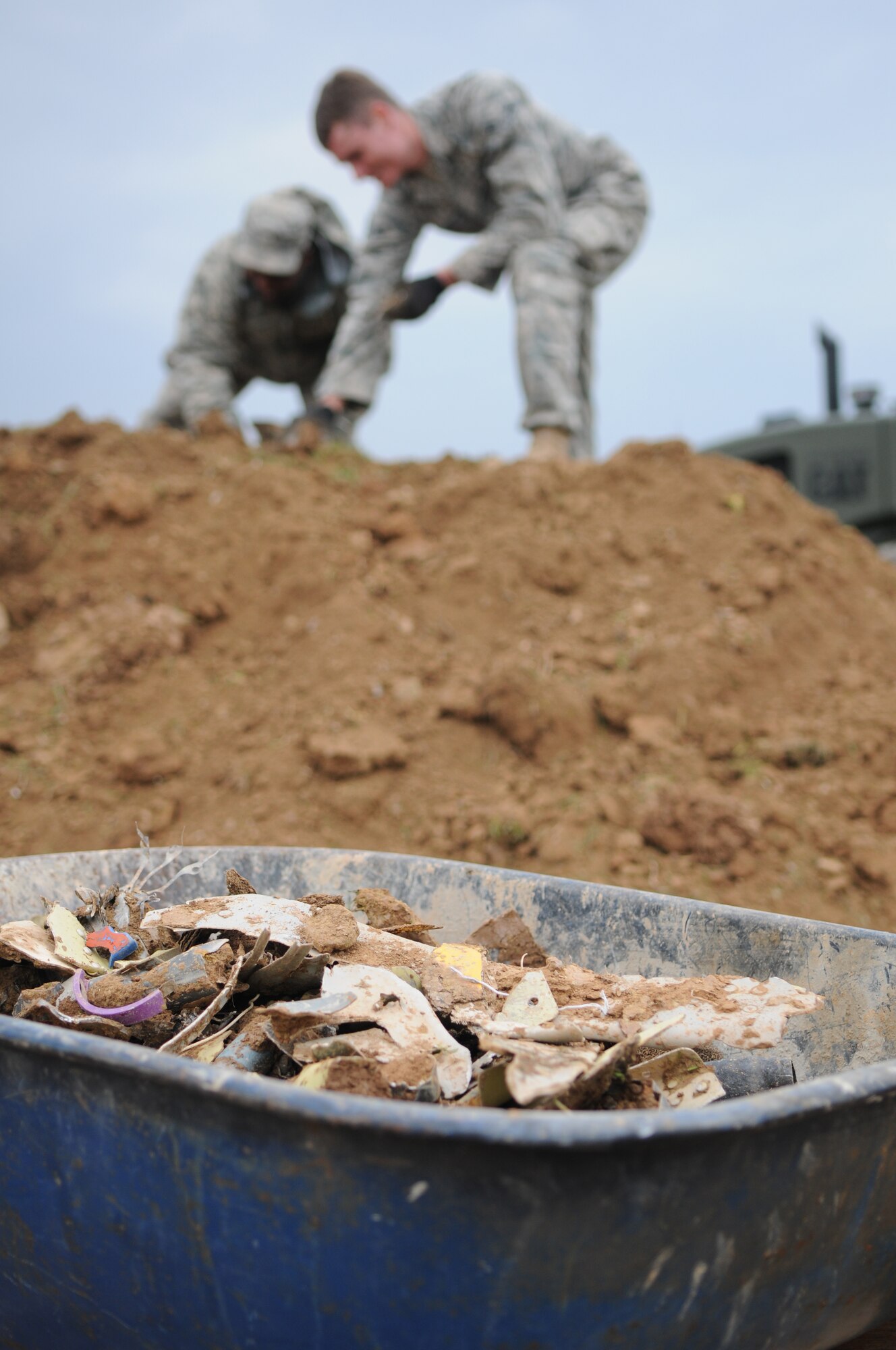 SPANGDAHLEM AIR BASE, Germany – 52nd Fighter Wing Airmen work with the 52ndCivil Engineer Squadron to clear debris from the crash site of an Air Force A-10 Thunderbolt II near Laufeld, Germany, April 14. The aircraft crashed April 1 in a field outside Laufeld, a town north of the city of Wittlich. The pilot, Lt. Col. Scott Hurrelbrink, 81st Fighter Squadron, here was treated for injuries at the Krankenhaus der Barmherzigen Bruder, and no one else was injured in the mishap. The Safety Investigation Board is continuing its investigation into the cause of the crash.  (U.S. Air Force photo/Airman 1st Class Matthew B. Fredericks)
