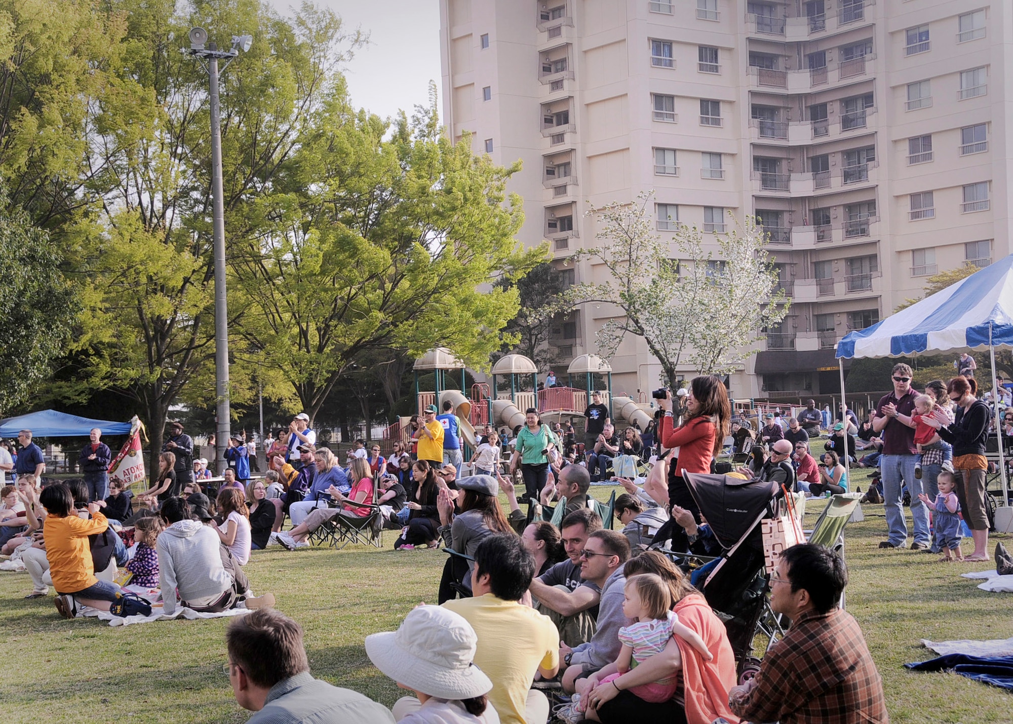 YOKOTA AIR BASE, Japan -- Yokota members watch as the rock band Days Gone By performs during Tomodachistock 2011 on April 16, 2011, at Yokota Air Base, Japan. More than 700 people gathered to enjoy music, friendship and food while helping the American Red Cross raise money to support the earthquake and tsunami relief efforts. (U.S. Air Force photo/Senior Airman Andrea Salazar)