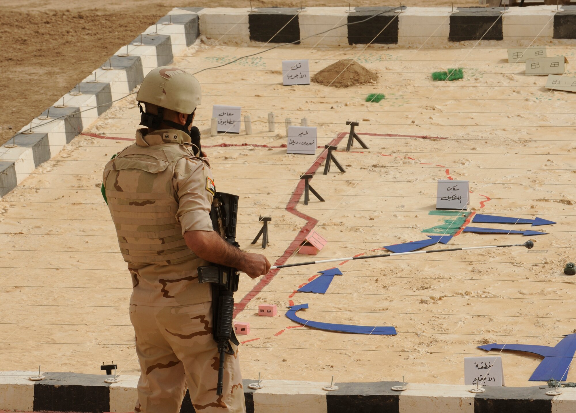 BESMAYA RANGE COMPLEX, Iraq – A soldier with the Iraqi Ground Forces Command, Ninth Mechanized Infantry Division, gives a briefing prior to a joint military demonstration near Baghdad April 18. The exhibition was just one of several ongoing, multi-phase exercises designed to further integrate the Iraqi air force, Iraqi Army Aviation Command and Iraqi army. (U.S. Air Force photo by Tech. Sgt. Randy Redman)