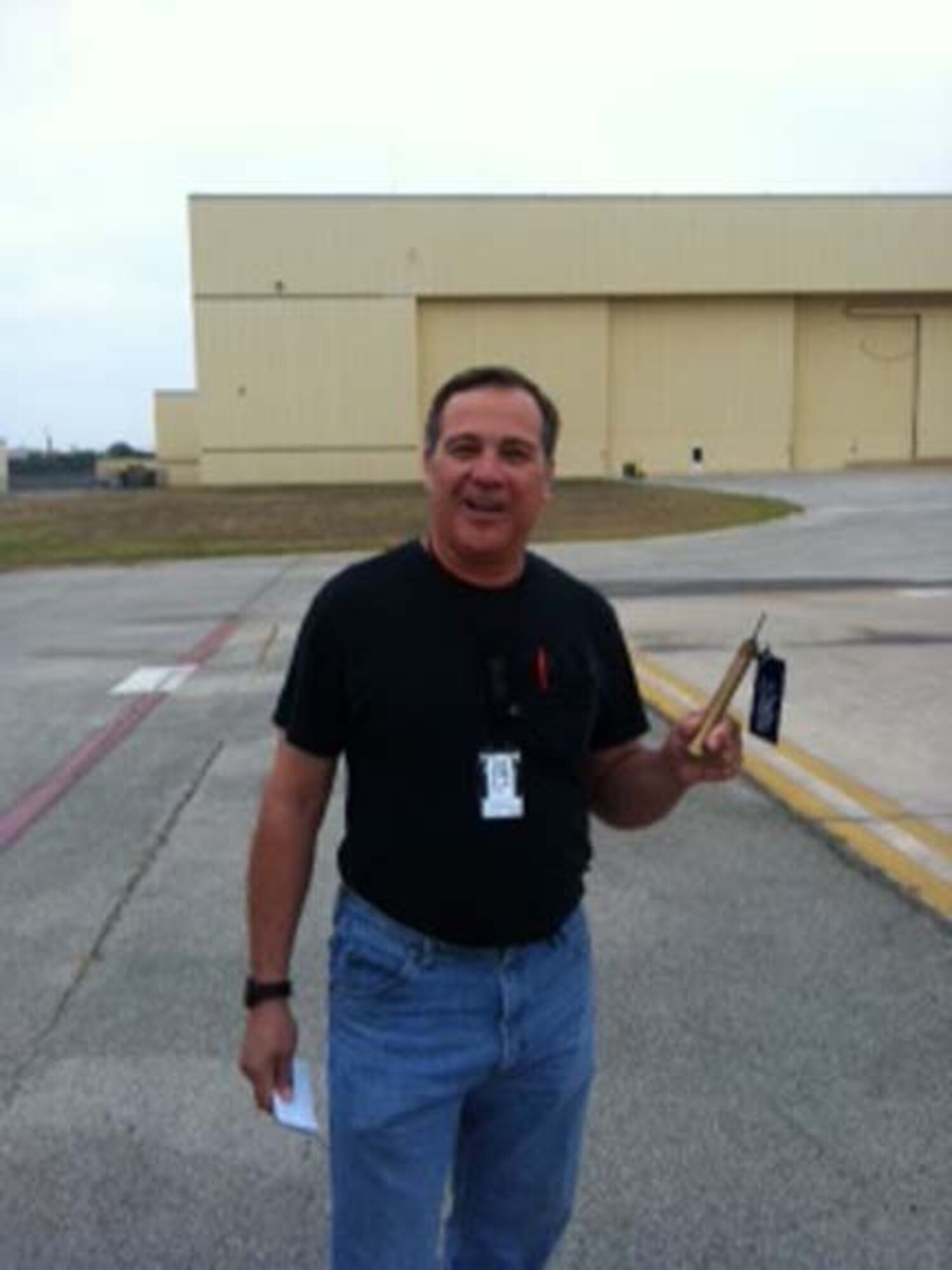 Technical Sergeant  Vincent Canchola, an aircraft electrician and environmental technician with the 433rd Aircraft Maintenance Squadron, holds the "Golden Bolt".  The bolt is planted by Colonel Dale Andrews, 433rd Airlift Wing vice commander, as part of the Foreign Object Damage (FOD) walks that are conducted every Monday morning. The walks ensure that there are no objects on the flightline that could be sucked into a jet engine and cause damage. (U.S. Air Force photo/ Col. Dale Andrews) 