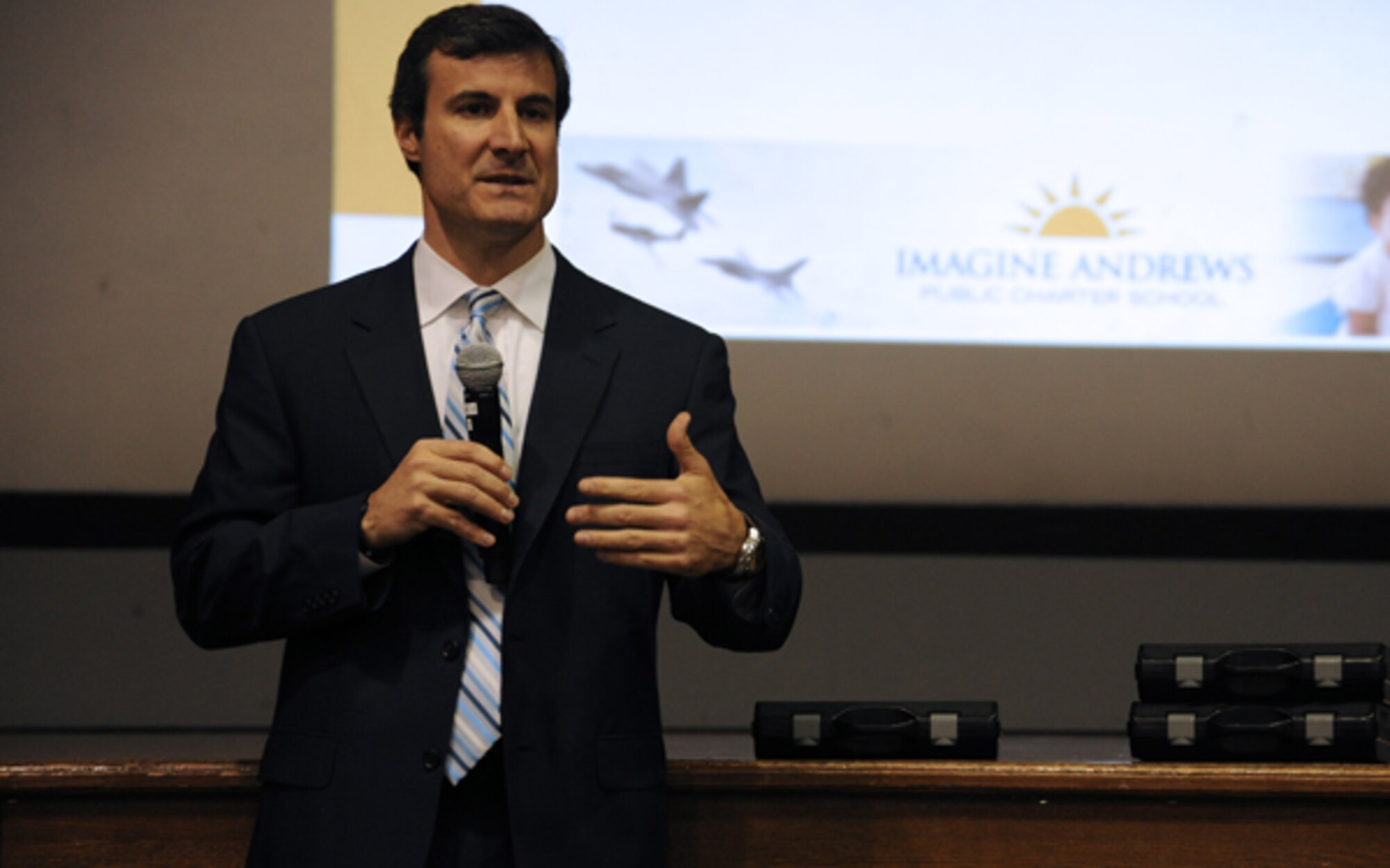 Mr. Pat Crain, Imagine Schools Maryland Regional director, addresses members of the Joint Base Andrews community at the Imagine Andrews Charter School town hall meeting at the base theater April 14. The meeting offered the families of children accepted into the school an opportunity to ask school officials questions on a wide range of topics including school uniforms, hiring process for teachers, enrollment procedures and school hours.