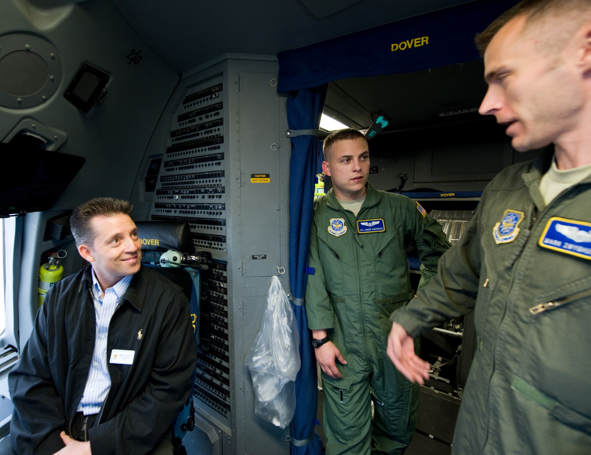 Tim Horn (left), Dover Downs vice president of finance and honorary commander for 436th Comptroller Squadron, is shown the ropes inside the cockpit of a C-17 by Senior Airman Landon Greenwood (middle), 3rd Airlift Squadron loadmaster, and Capt. Mark Zwyghuizen, 3 AS C-17 pilot, April 13, 2011, at Dover Air Force Base, Del. (U.S. Air Force photo by Airman 1st Class Jacob Morgan)