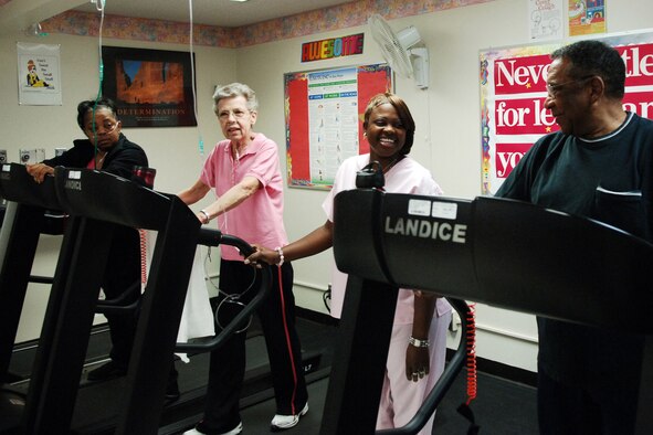 Men and women exercising on treadmills.