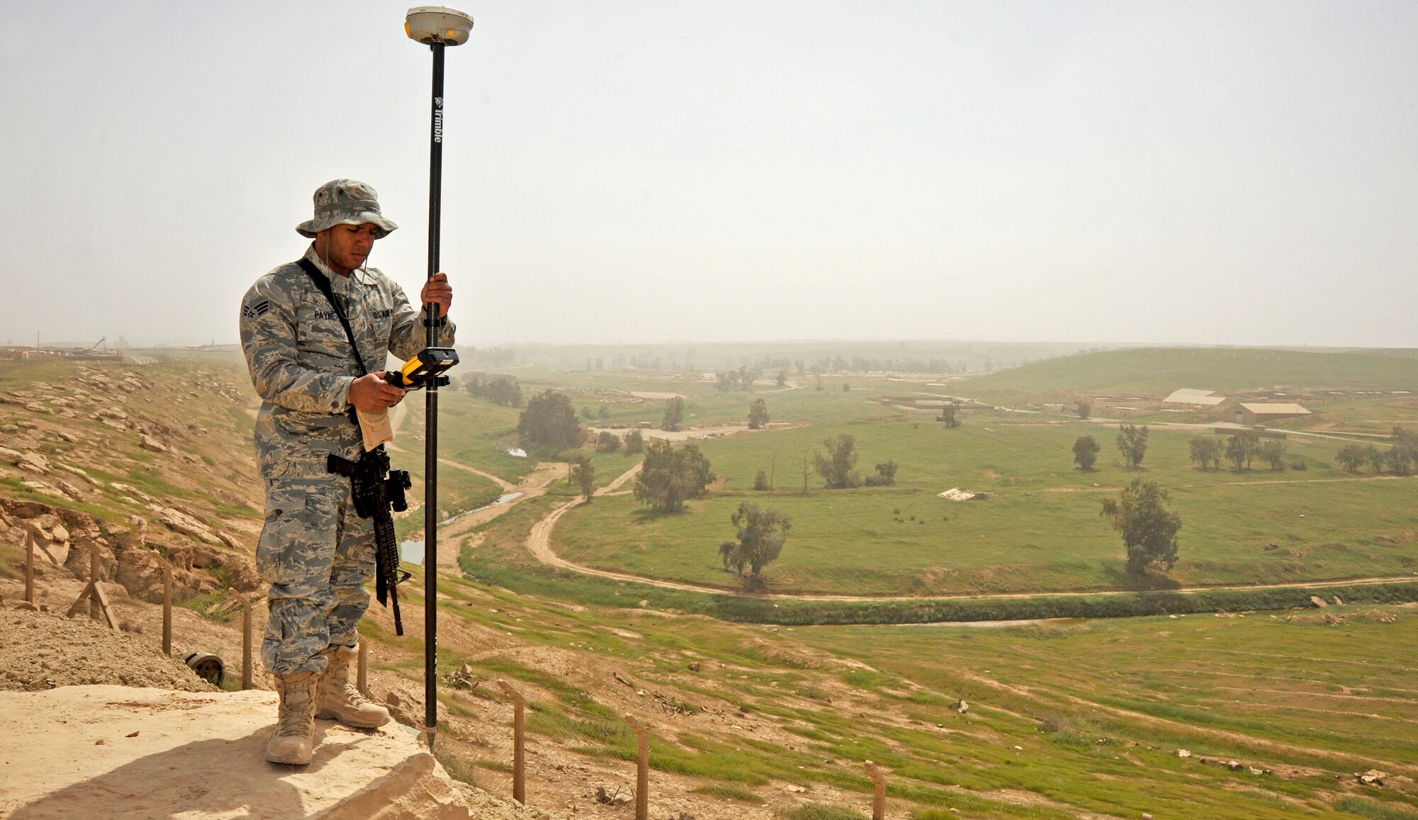 Senior Airman Michael Payne, a 467th Expedition Prime Beef Squadron engineering assistant, uses site surveying equipment, April 13, 2011, at Contingency Operating Site Marez. (U.S. Air Force photo by Senior Airman Andrew Lee/Released)