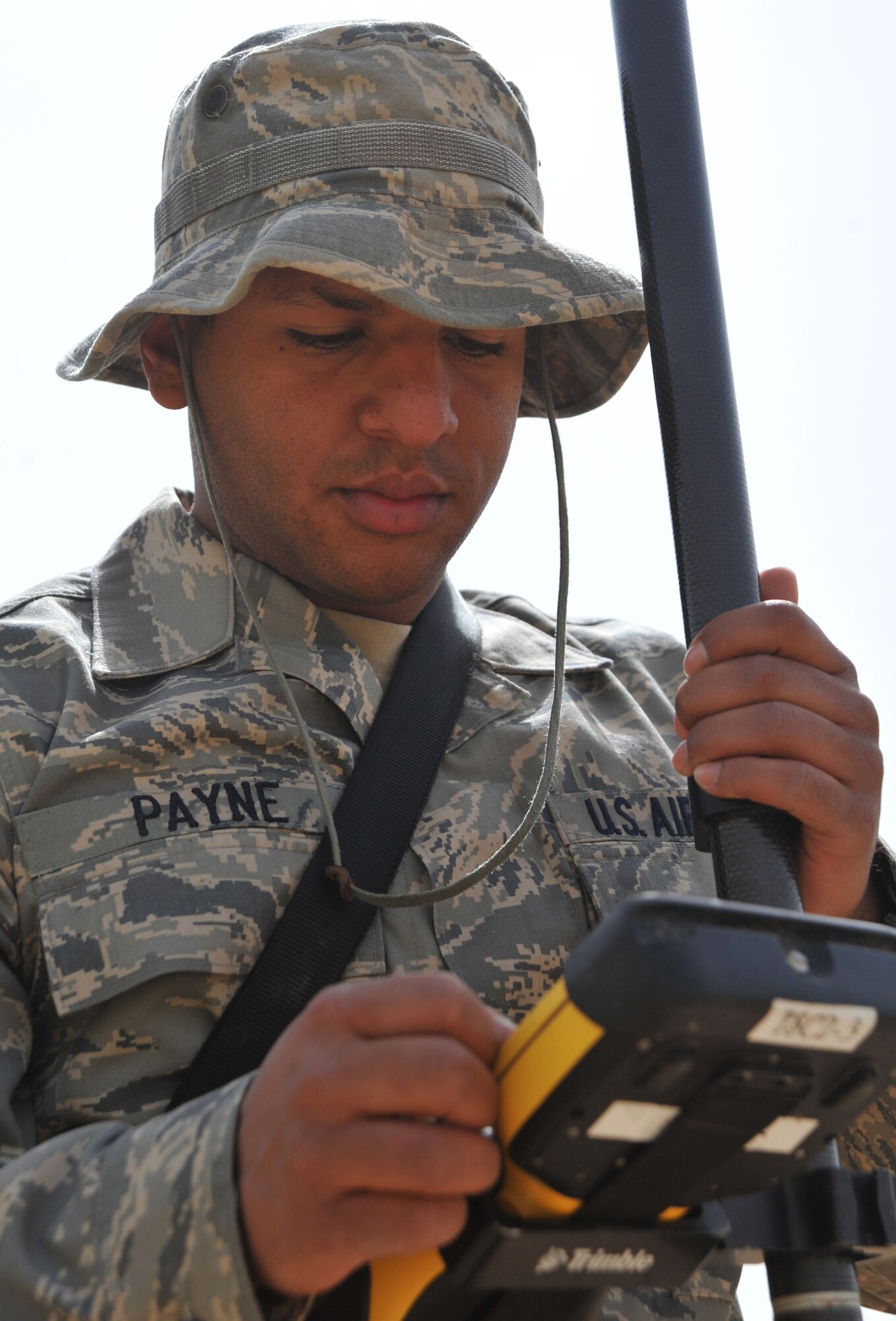 Senior Airman Michael Payne, a 467th Expedition Prime Beef Squadron engineering assistant, uses a handheld control for site surveying equipment, April 13, 2011, at Contingency Operating Site Marez. (U.S. Air Force photo by Senior Airman Andrew Lee/Released)