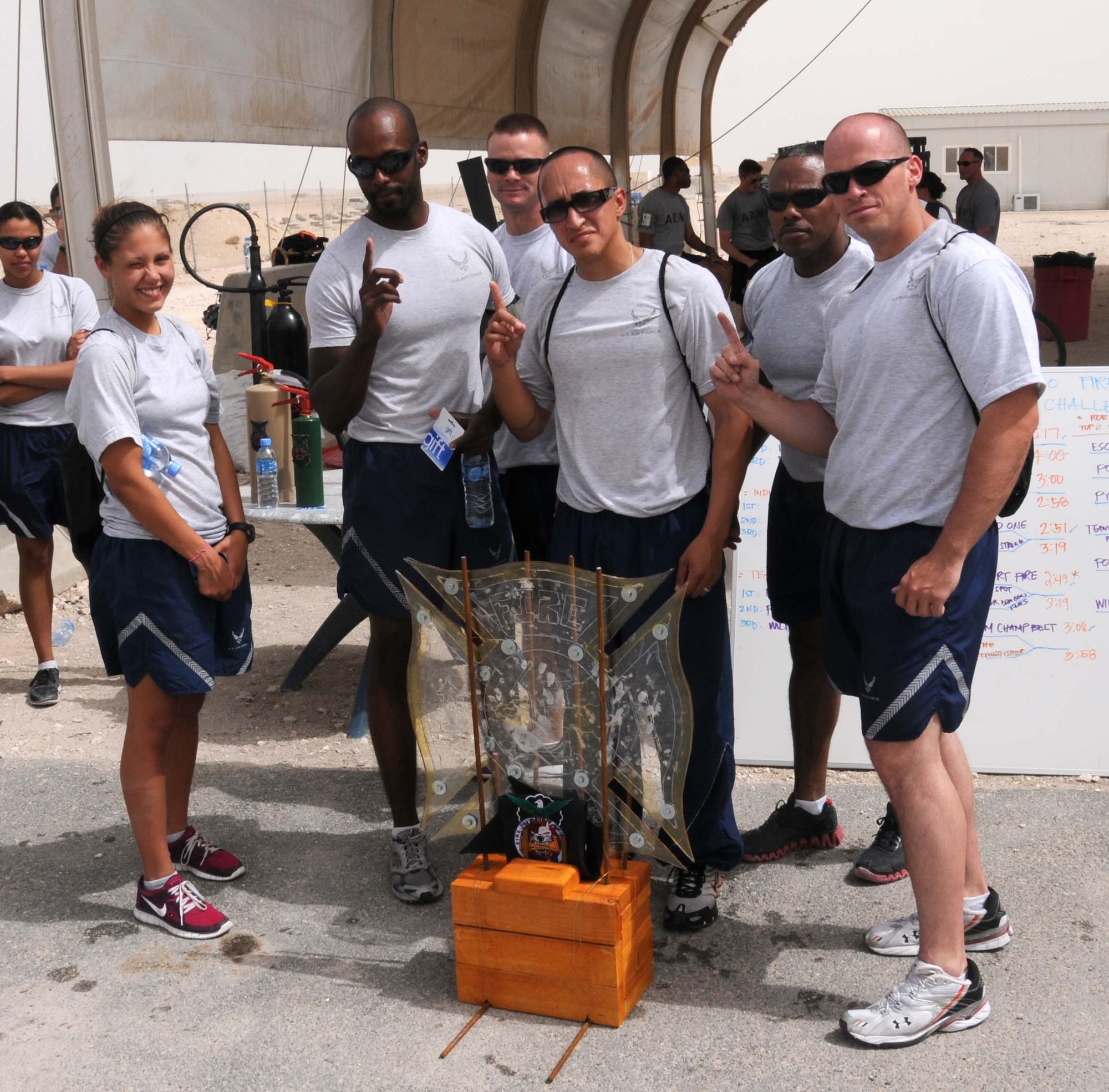 Airmen from the 379th Expeditionary Civil Engineer Squadron pose for a victory photo April 16 in Southwest Asia.   A total of 20 teams competed in the Fire Muster which consisted of relaying a baton through different stages of the course. (U.S. Air Force photo/Staff Sgt Anthony Graham)