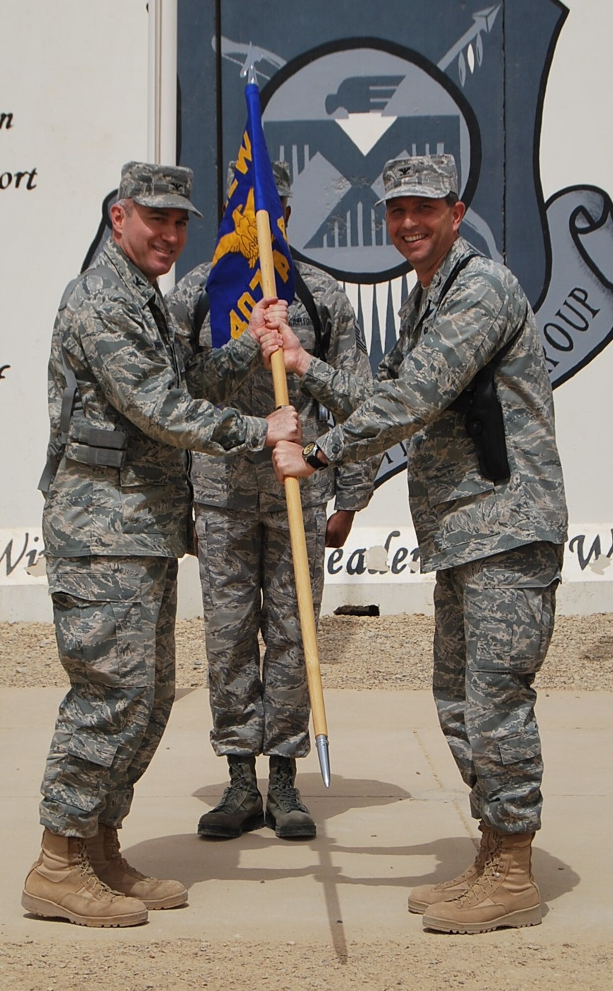 ALI AIR BASE, Iraq -- Col. Theodore Mathews Jr., right, a veteran KC-135 Stratotanker pilot, takes command of the 407th Air Expeditionary Group during a change of command ceremony April 16. More than 75 servicemembers and civilians attended the 407th Air Expeditionary Group's change of command ceremony, including Col. Michael Jordan, left, 321st Air Expeditionary Wing vice commander, who presided over the ceremony. (U.S. Air Force photo/Staff Sgt. Ben Harper)