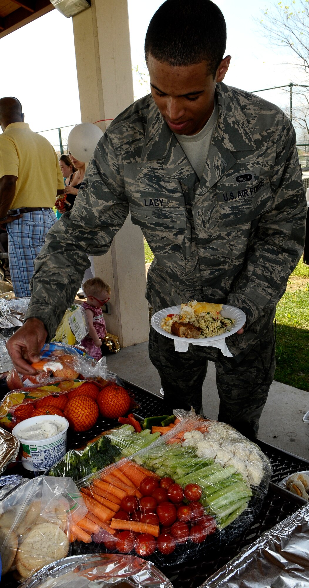 Airman 1st Class Kevin Lacy, 81st Fighter Squadron A-10 Thunderbolt crew chief, serves himself some food at a barbecue held by Aviano Air Base spouses April 9 at Freedom Park here. Eighty Aviano spouses and three sponsors coordinated a barbecue event for servicemembers deployed to Aviano, offering macaroni and cheese, hot dogs, burgers, chicken and other dishes, including a variety of fresh-baked desserts as an alternative to Meals-Ready-to-Eat and meals prepared at the base dining facilities.  (U.S. Air Force photo by Airman 1st Class Katherine Windish)