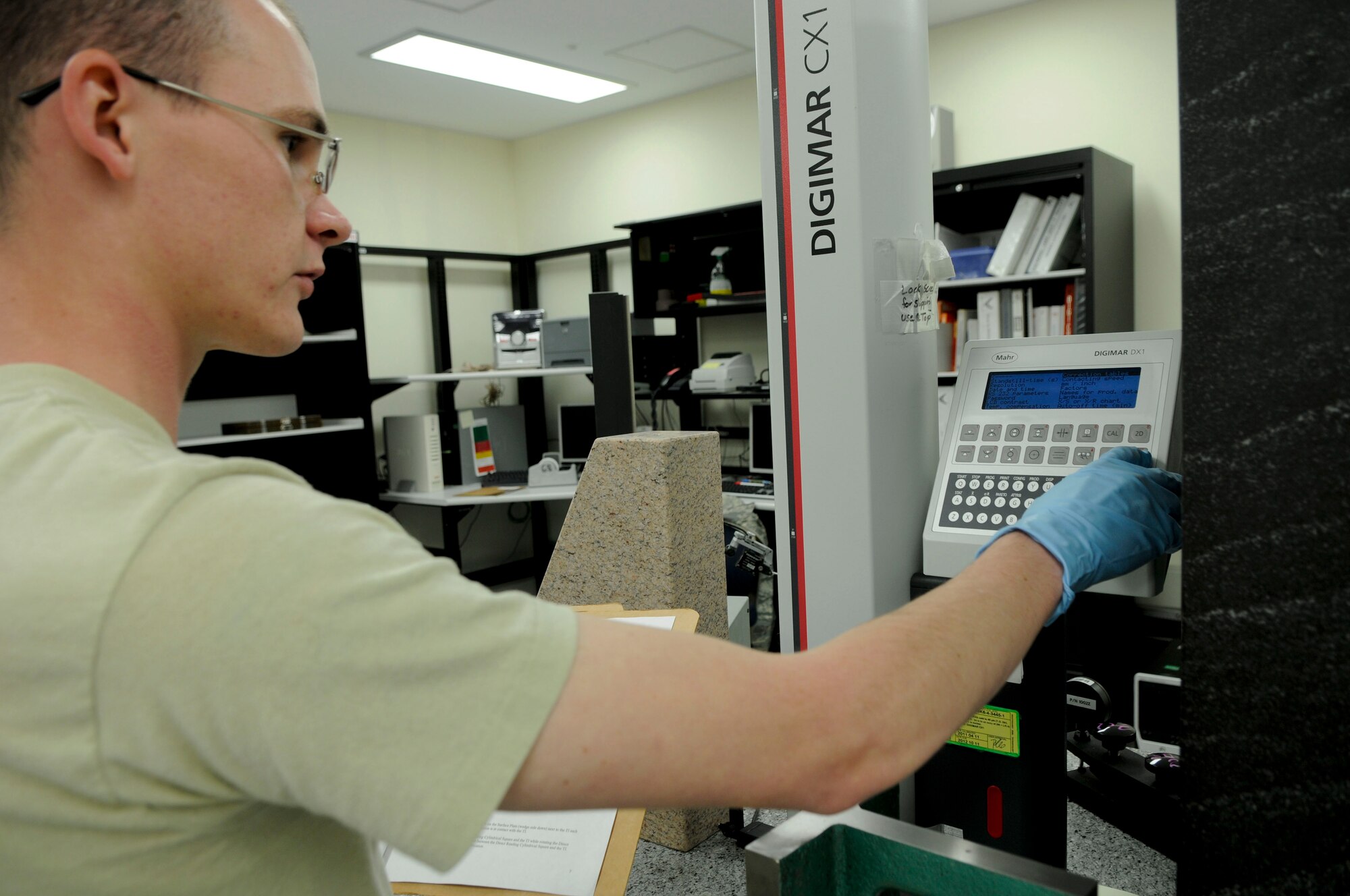 Senior Airman Sean Pentz, a precision measurement equipment laboratory journeyman of the 18th Component Maintenance Squadron, calibrates precise linear measurements in the "68 degree room." Pentz was born at Travis Air Force Base, Calif. and joined the Air Force as open electronic. "I'm happy with my job. At first you think about Dexter's Lab and lab suits but I would like to advance in this job." (U.S. Air Force photo/Airman 1st Class Brooke P. Beers)