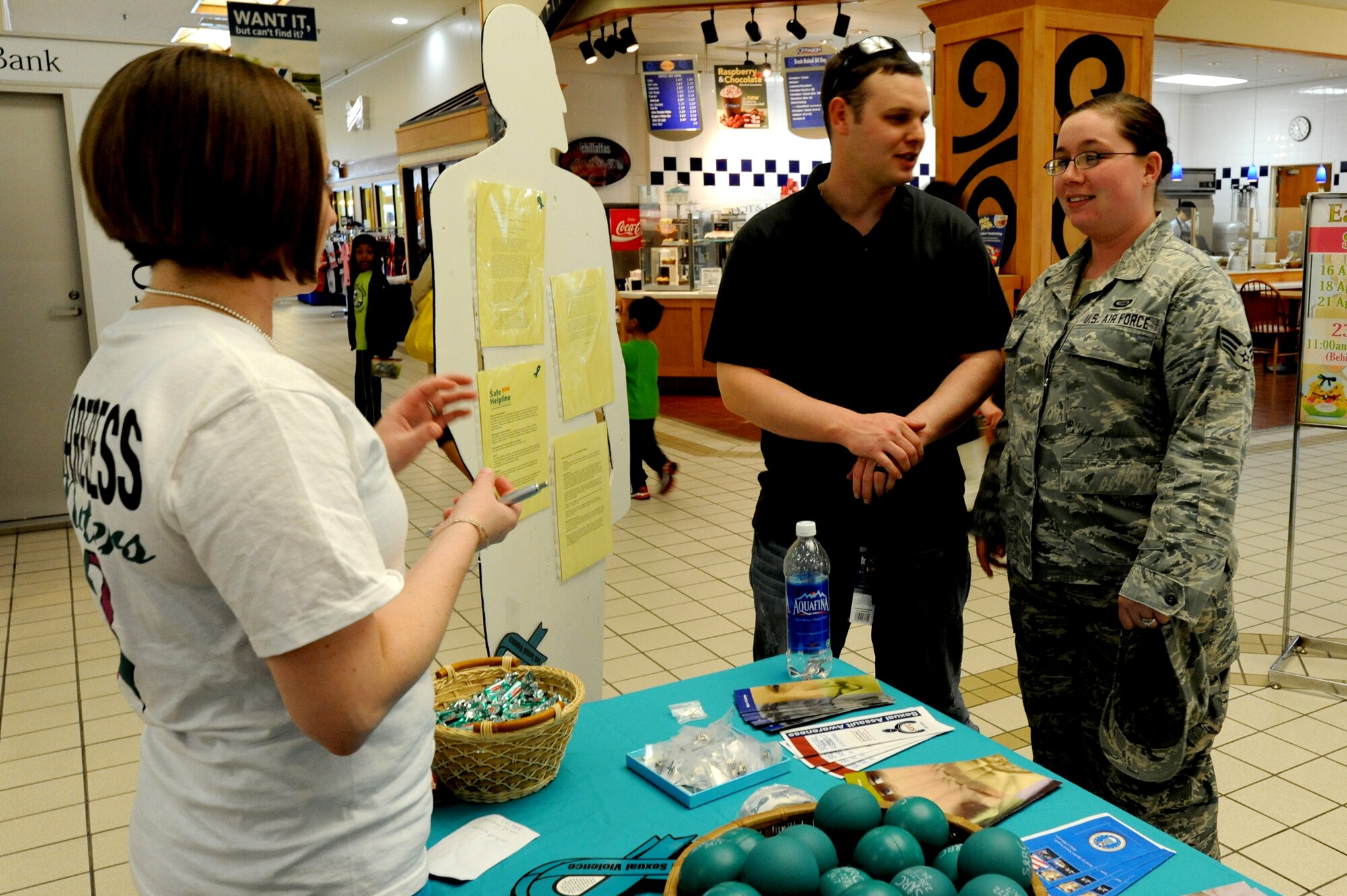 MISAWA AIR BASE, Japan - Capt. Brandi Rountree, 35th Fighter Wing, left, speaks to Senior Airmen Jeremy and Sarah Pryor, 301st Intelligence Squadron, about becoming a sexual assault response coordinator 16 April.  The SARC office setup the informational display to provide information to all Misawa residents.  (U.S. Air Force Photo by Staff Sgt. April Quintanilla/Released)