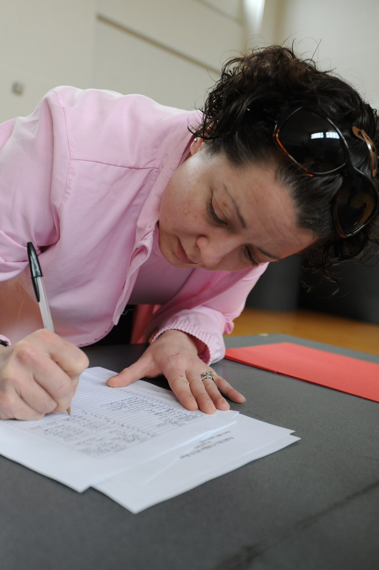 MISAWA AIR BASE, Japan ? Master Sgt. Stephanie Chrisman, 373rd Intelligence Service Reconnaissance Group, signs up for the Sakura 5 Miler fun run at the Freedom Fitness Center 16 April.  The Sakura run is the first run of the season hosted by the 35th Force Support Squadron.  (U.S. Air Force Photo by Staff Sgt. April Quintanilla/Released)