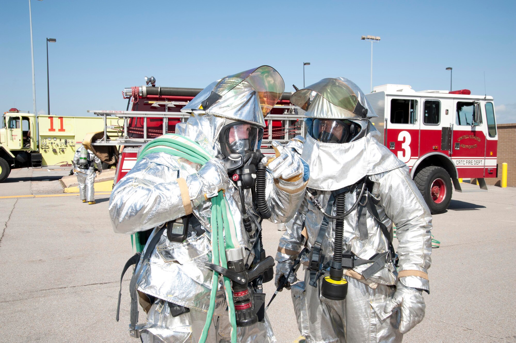 During the April unit training assembly, Senior Airman Earl Jordan (left) and Tech. Sgt. Michael Coleman, 403rd Civil Engineer Squadron fire fighters, prepare to investigate a building during a structural fire exercise at the Air National Guard Combat Readiness Training Center, Miss. Members from various CE career fields practice their job-specific skills during UTAs and annual tours to remain deployable for global contingencies. (U.S. Air Force photo by Tech. Sgt. Ryan Labadens)
