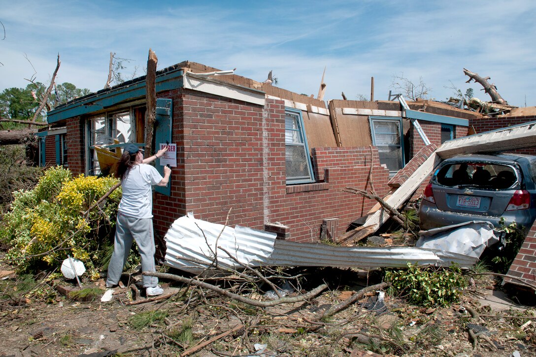 A Fayetteville, N.C., resident nails a danger sign to the front of the ...