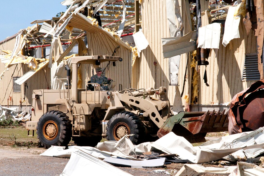A U.S. Army soldier moves debris with a bulldozer on Fort Bragg, N.C., April 18, 2011, as part of the effort to clean up areas hit by a tornado, which struck Fayetteville and the southern edge of Fort Bragg, April 16. The soldier is assigned to the 307th Engineer Battalion.