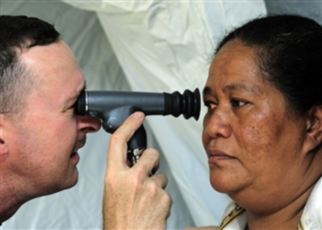 U.S. Navy optometrist Lt. Cmdr. Randy Birt (left) uses an ophthalmoscope to check the retina of a Tongan woman at a medical site in Tuanekivale, Tonga, during Pacific Partnership on April 16, 2011.  Pacific Partnership is an annual deployment of forces designed to strengthen maritime and humanitarian partnerships during disaster relief operations, while providing humanitarian, medical, dental and engineering assistance to nations of the Pacific.  