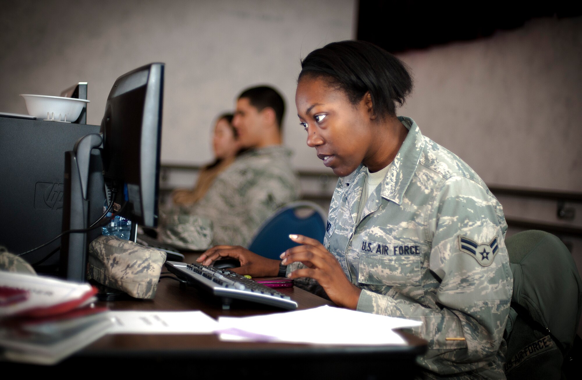 YOKOTA AIR BASE, Japan -- Airman 1st Class Carmen Turner, 374th Comptroller Squadron finance representative, helps a family with their travel voucher at a ReStart briefing at the Airman & Family Readiness Center here April 21.  ReStart is designed to help families that left during the voluntary authorized departure in-process with the base after returning. (U.S. Air Force photo/Staff Sgt. Chad C. Strohmeyer)