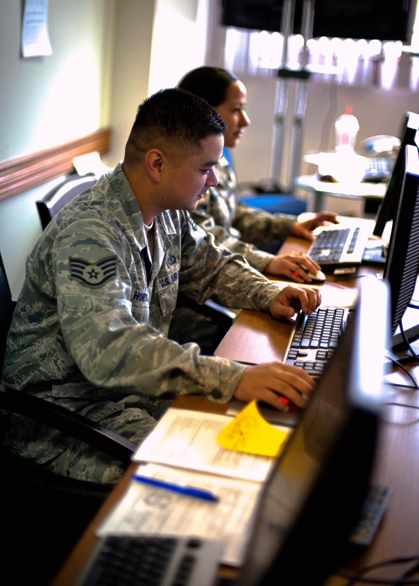 YOKOTA AIR BASE, Japan -- Staff Sgt. Joe Horton, 374th Comptroller Squadron finance customer service representative, mans one of the desks at the Airman & Family Readiness call center at the A&FRC here April 21.  The call center has been operating 24 hours in support of Operation Tomodachi. (U.S. Air Force photo/Staff Sgt. Chad C. Strohmeyer)