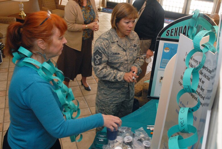 VANDENBERG AIR FORCE BASE, Calif. -- Susan Haury, Sexual Assault Prevention and Response assistant, shows Chief Master Sgt. Angelica Johnson, 30th Space Wing command chief, SARC promotional items Wednesday, April 20, 2011, in the Pacific Coast Club here. The SARC team’s mission is to reinforce the Air Force's commitment to eliminate incidents of sexual assault through a comprehensive policy centering on awareness and prevention, training and education, victim advocacy, response, reporting, and accountability. (U.S. Air Force photo/Jerry E. Clemens, Jr.)