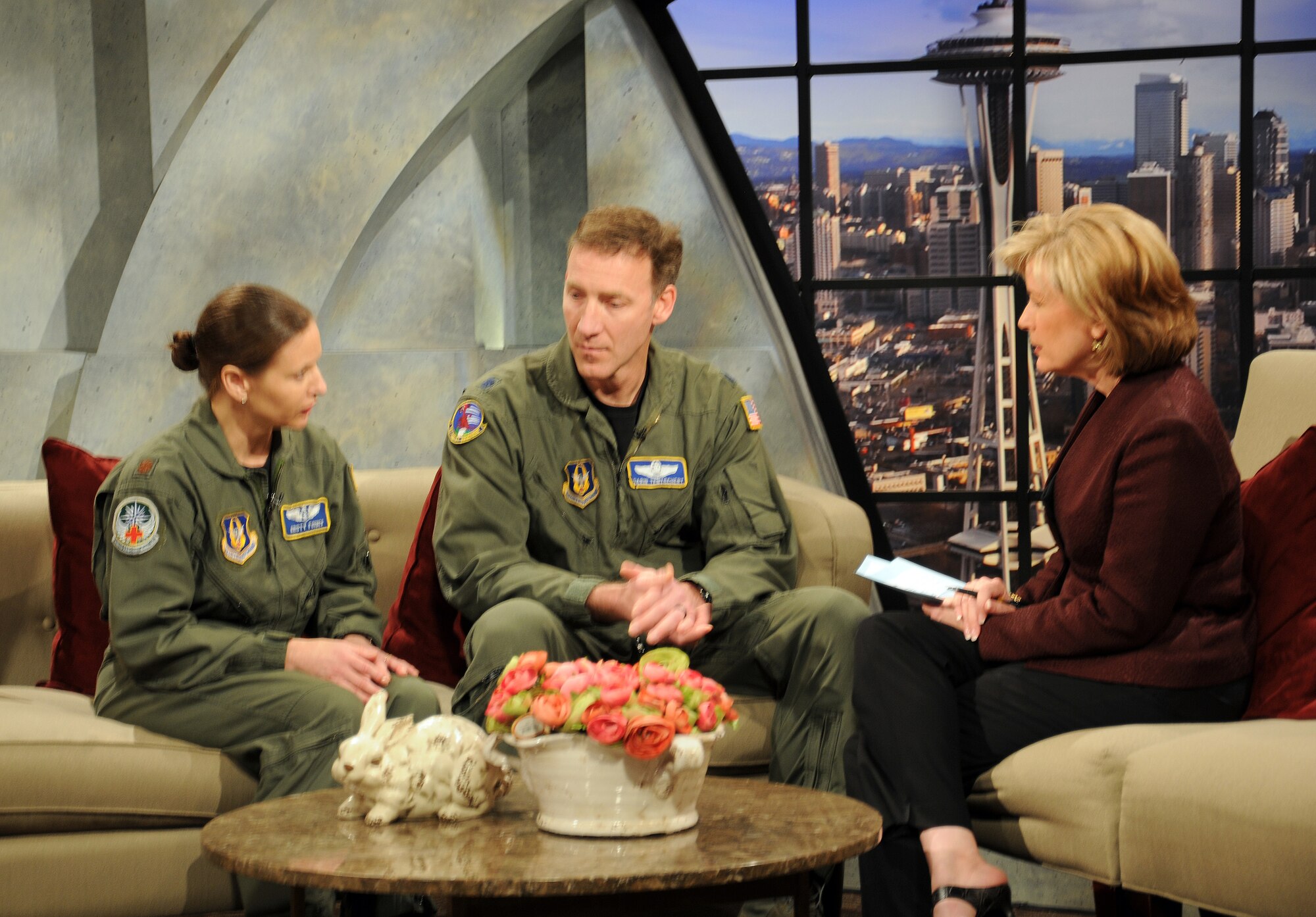 Lt. Col. Garin Tentschert, center, chief pilot with the 97th Airlift Squadron, and Maj. Kristi Forbes, left, a flight nurse with the 446th Aeromedical Evacuation Squadron, both out of McChord Field, Wash., discuss balancing their Reserve and civilian careers with their family roles on King TV Seattle's New Day Northwest hosted by Margaret Larson, April 20, 2011. New Day Northwest is an hour-long show with the goal of informing and entertaining the public with current events. (U.S. Air Force photo by 2nd Lt. Denise Hauser/Released)