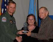 Don and Shirley Marquardt, right and center, receive a Volunteer Longevity Award from Col. Russ Mack, 71st Flying Training Wing commander, during a ceremony held April 14 at Eisenhower Elementary School on Vance AFB, Okla. (U.S. Air Force photo/ 2nd Lt. Kiersten Thompson)