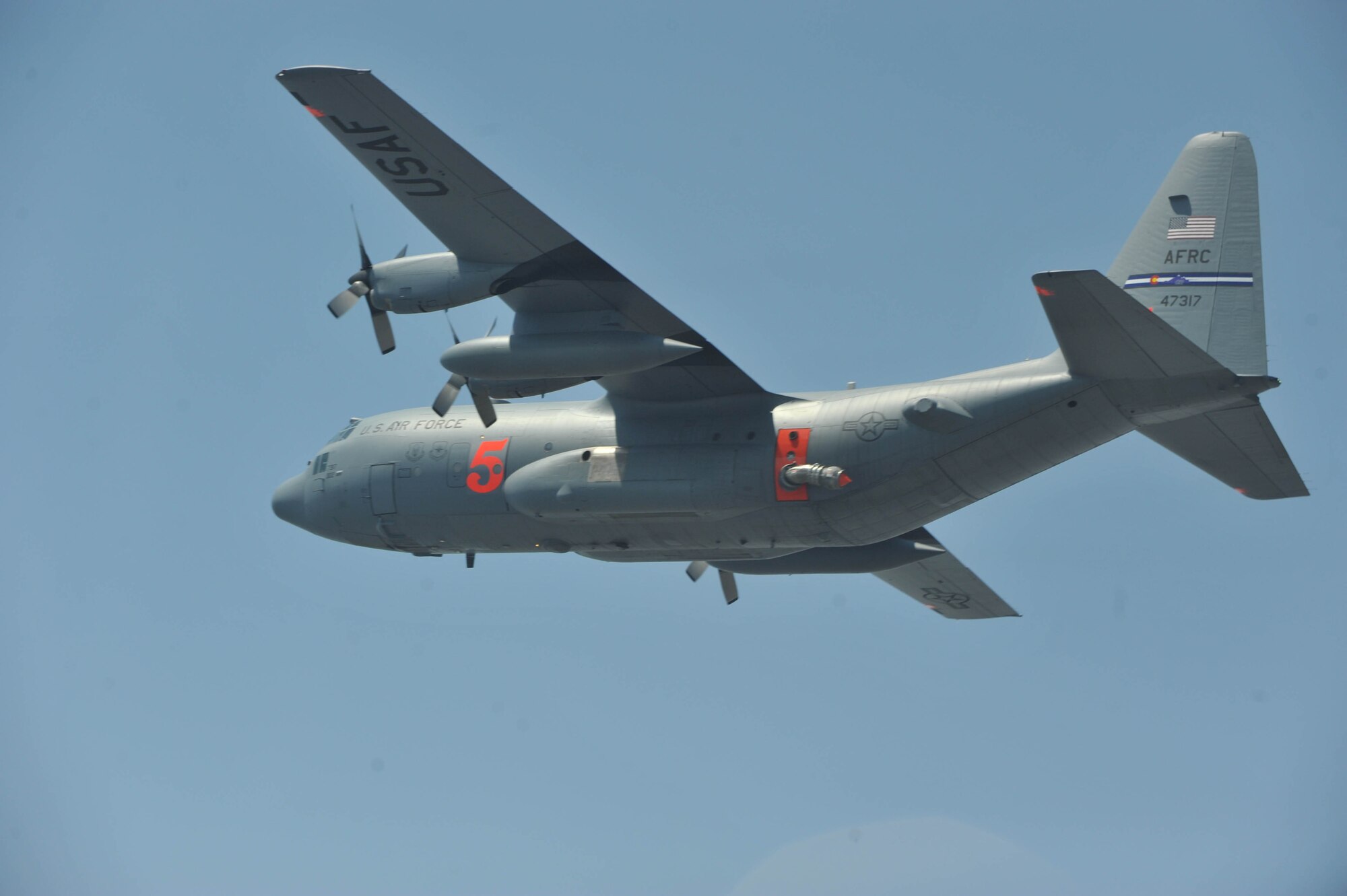 An Air Force Reserve C-130 Hercules from the 302nd Airlift Wing, Peterson Air Force Base, Colo., equipped with a U.S. Forest Service Modular Airborne Fire Fighting System, flies toward a wildfire west of Austin, Texas, April 17. Six MAFFS C-130s, deployed by U.S. Northern Command to Texas, have conducted several aerial firefighting missions over that state's fires in the past two days. (U.S. Air Force photo/Staff Sgt. Quinton Russ)
