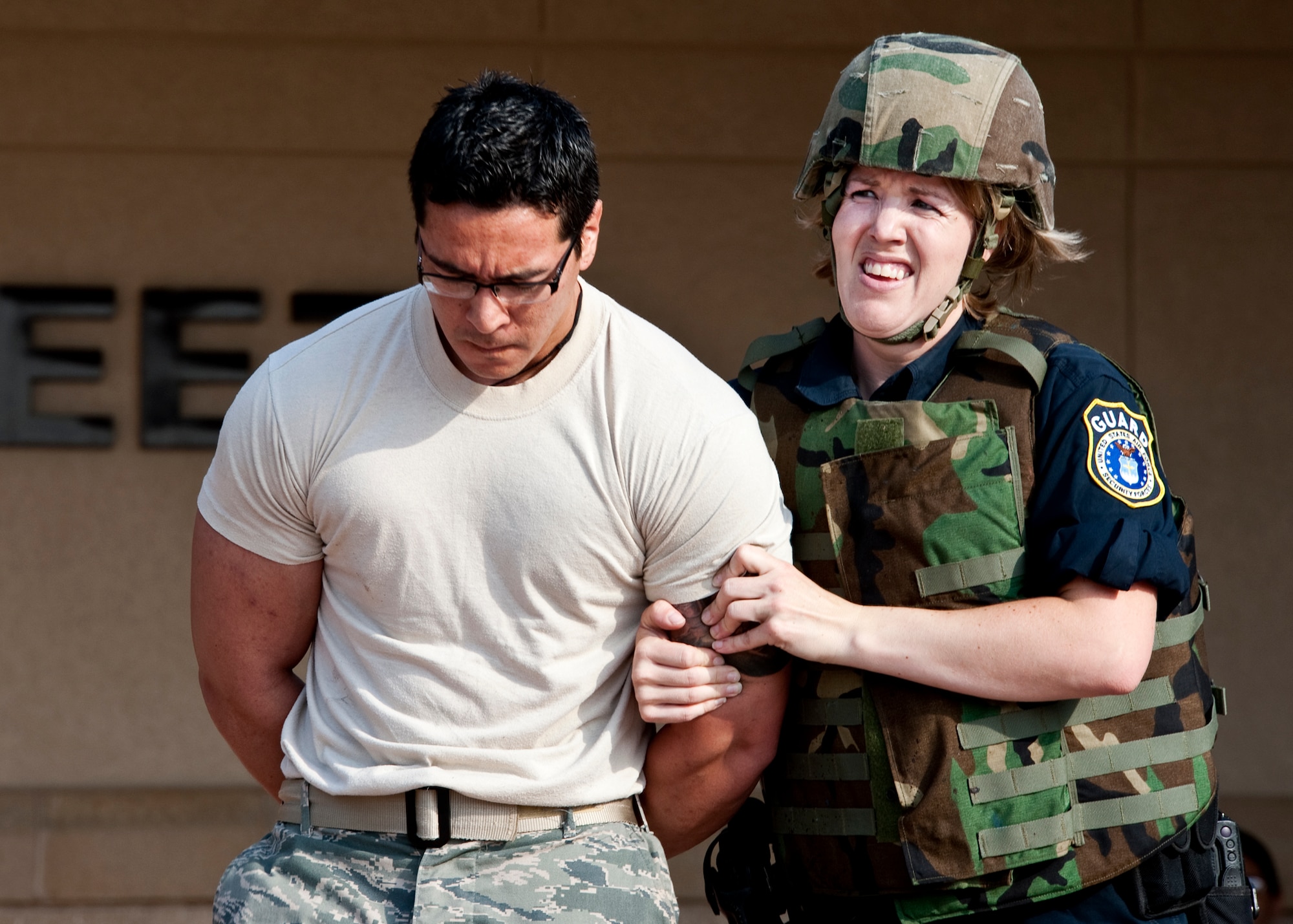 Officer Tracy McDaniel, 96th Security Forces Squadron, escorts a “suspect” out of the dining facility after a stand-off during an active shooter exercise at Eglin Air Force Base, Fla., April 20.  Security Forces personnel entered the facility where two “shooters” were holding hostages.  They quickly subdued or killed the “shooters” and evacuated the hostages.  (U.S. Air Force photo/Samuel King Jr.)