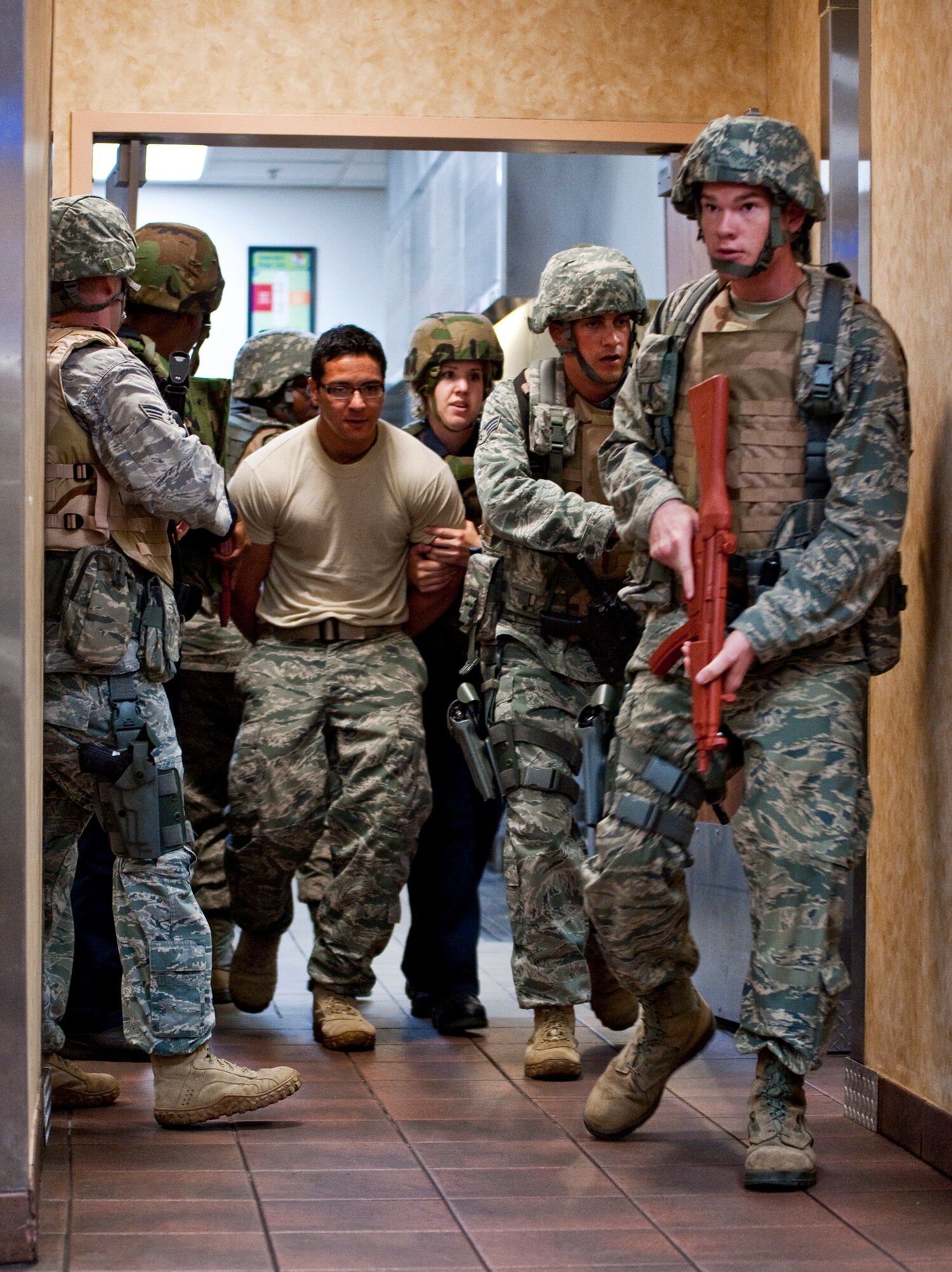 Security Forces personnel exit the kitchen area of the dining facility with a “suspect after a stand-off during an active shooter exercise at Eglin Air Force Base, Fla., April 20.  Security Forces personnel entered the facility where two “shooters” were holding hostages.  They quickly subdued or killed the “shooters” and evacuated the hostages.  (U.S. Air Force photo/Samuel King Jr.)