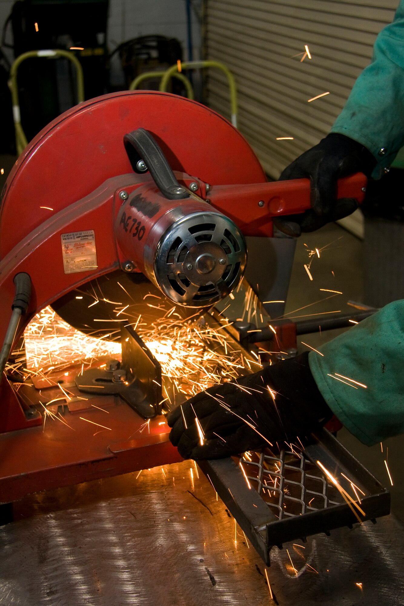 GRISSOM AIR RESERVE BASE, Ind. -- Sparks fly as Senior Airman Shawn Cherty, 434th Maintenance Squadron metals technology apprentice, uses a cutoff saw to slice through a steel step he's working on here at Grissom recently. The step was installed on a B-5 aircraft maintenance platform to close a gap between the platform and ladder. (U.S. Air Force photo/Tech. Sgt. Mark R. W. Orders-Woempner)
