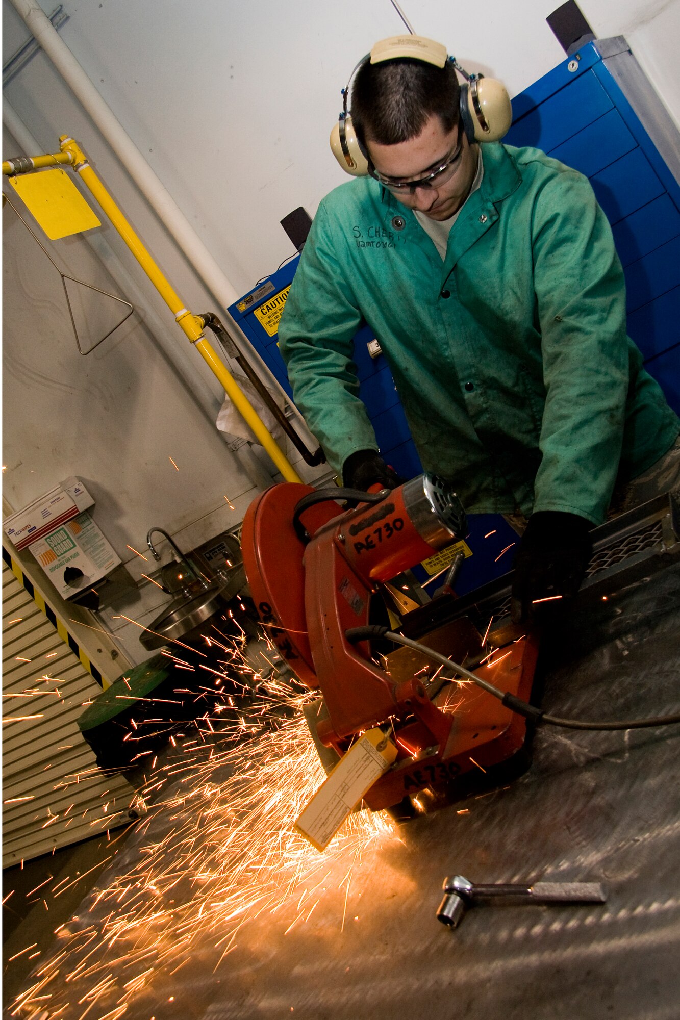 GRISSOM AIR RESERVE BASE, Ind. -- Sparks fly as Senior Airman Shawn Cherty, 434th Maintenance Squadron metals technology apprentice, uses a cutoff saw to slice through a steel step he's working on here at Grissom recently. The step was installed on a B-5 aircraft maintenance platform to close a gap between the platform and ladder. (U.S. Air Force photo/Tech. Sgt. Mark R. W. Orders-Woempner)
