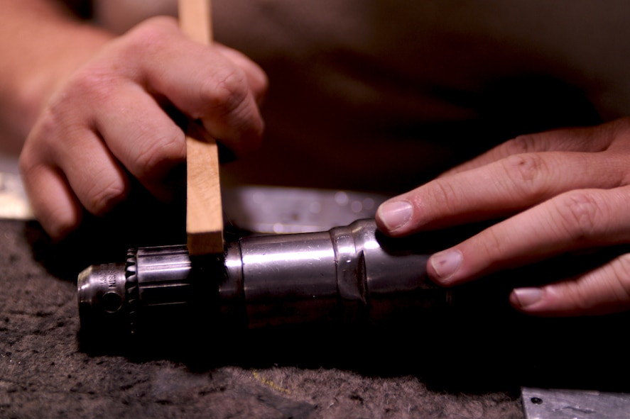 An Airman from the 23rd Equipment Maintenance Squadron uses a stiff brush to remove debris from a drill as a 7-level inspection is conducted on a toolbox at Moody Air Force Base, Ga., April 20. Each toolbox from the 23rd EMS is inspected weekly to ensure all tools work and accountability is conducted to ensure no tool is missing. (U.S. Air Force photo/Airman 1st Class Benjamin Wiseman)(RELEASED)