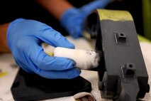 An Airman from the 23rd Equipment Maintenance Squadron finishes painting the hoist support brackets off an HH-60G Pave Hawk at Moody Air Force Base, Ga., April 20. The 23rd EMS is responsible for corrosion control on the A-10C Thunderbolt II, the Pave Hawk, and smaller components of the HC-130P Combat King. (U.S. Air Force photo/Airman 1st Class Benjamin Wiseman)(RELEASED)