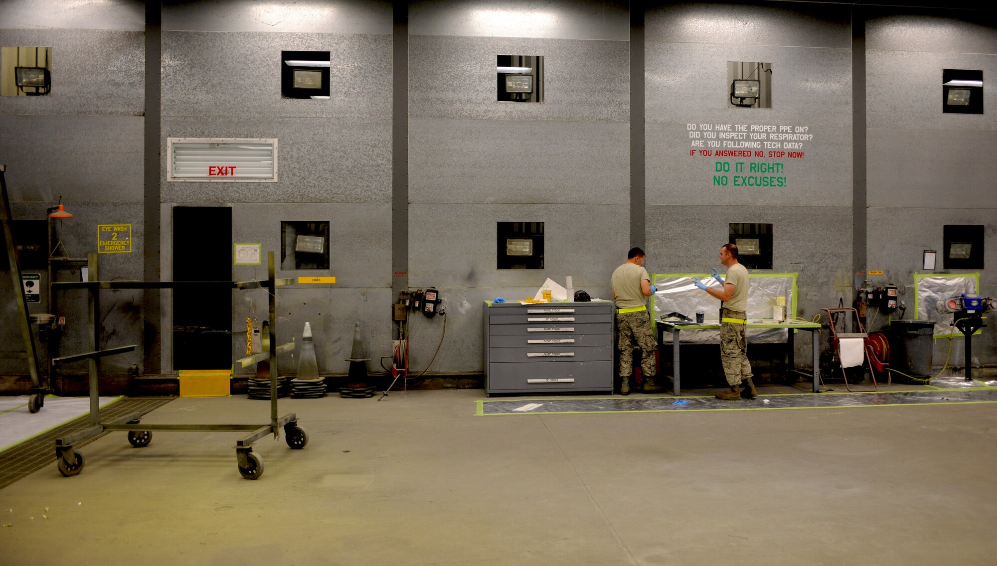 Staff Sgt. Jordan Keller and Airman 1st Class Taylor Jacobs, 23rd Equipment Maintenance Squadron aircraft structural maintenance, prepare to paint hoist support brackets off an HH-60G Pave Hawk at Moody Air Force Base, Ga., April 20. The 23rd EMS paints the metal components to prevent the corrosion and to beautify the aircraft stationed at Moody. (U.S. Air Force photo/Airman 1st Class Benjamin Wiseman)(RELEASED)