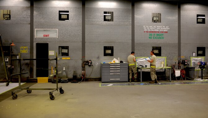 Staff Sgt. Jordan Keller and Airman 1st Class Taylor Jacobs, 23rd Equipment Maintenance Squadron aircraft structural maintenance, prepare to paint hoist support brackets off an HH-60G Pave Hawk at Moody Air Force Base, Ga., April 20. The 23rd EMS paints the metal components to prevent the corrosion and to beautify the aircraft stationed at Moody. (U.S. Air Force photo/Airman 1st Class Benjamin Wiseman)(RELEASED)