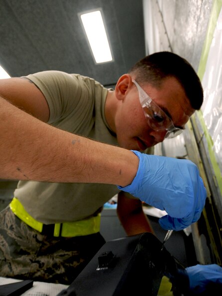 Airman 1st Class Taylor Jacobs, 23rd Equipment Maintenance Squadron aircraft structural maintenance apprentice, applies a final coat of paint to an HH-60G Pave Hawk hoist support bracket inside the corrosion hangar at Moody Air Force Base, Ga., April 20. The paint applied to the metal parts of the aircraft provides a barrier between the metal and environmental element to prevent corrosion. (U.S. Air Force photo/Airman 1st Class Benjamin Wiseman)(RELEASED)