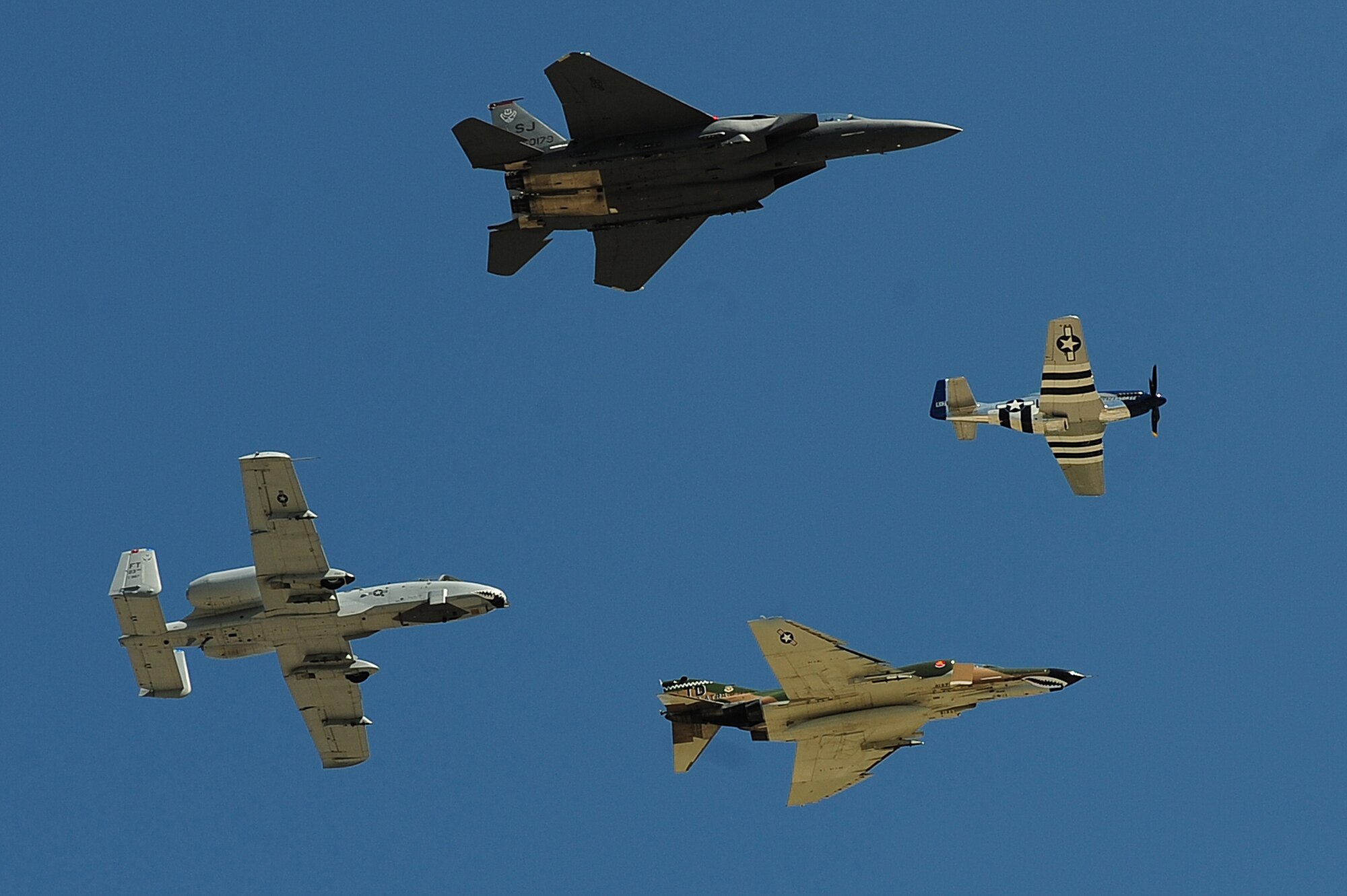 SEYMOUR JOHNSON AIR FORCE BASE, N.C. -- (Clockwise) An F-15E Strike Eagle, P-51 Mustang, F-4 Phantom and A-10 Thunderbolt II perform a heritage flight during the Wings Over Wayne Air Show and Open House here, April 17, 2011. Each of these aircraft have been assigned to the 4th Fighter Wing throughout the years. (U.S. Air Force photo/Senior Airman Rae Perry) (RELEASED)