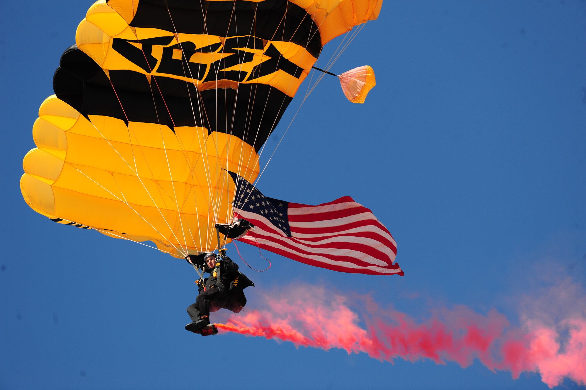 SEYMOUR JOHNSON AIR FORCE BASE, N.C. -- U.S. Army Specialist Matthew Navarro glides to the ground with the American flag during the opening ceremony of the Wings Over Wayne Air Show and Open House here, April 17, 2011. Specialist Navarro performs with the U.S. Army Golden Knights Black Demonstration team. He hails from Lecanto, Fla. (U.S. Air Force photo/Senior Airman Rae Perry) (RELEASED)