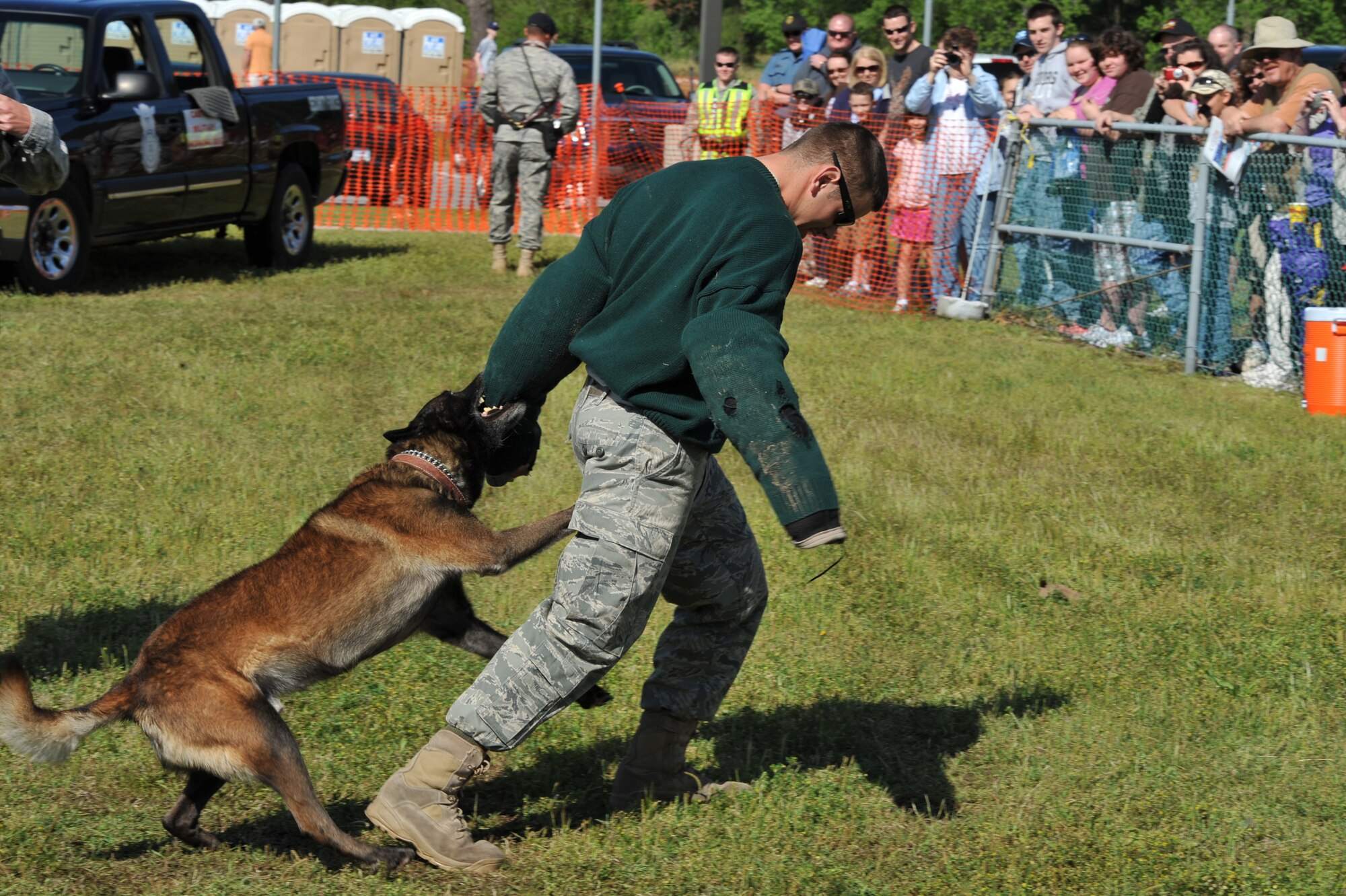 SEYMOUR JOHNSON AIR FORCE BASE, N.C. -- Senior Airman Matthew Halligan, 4th Security Forces Squadron, performs a military working dog demonstration with Ralph during the Wings Over Wayne Air Show and Open House here, April 17, 2011. Airman Halligan hails from Kendall, N.Y. (U.S. Air Force photo/Senior Airman Whitney Lambert) (RELEASED)