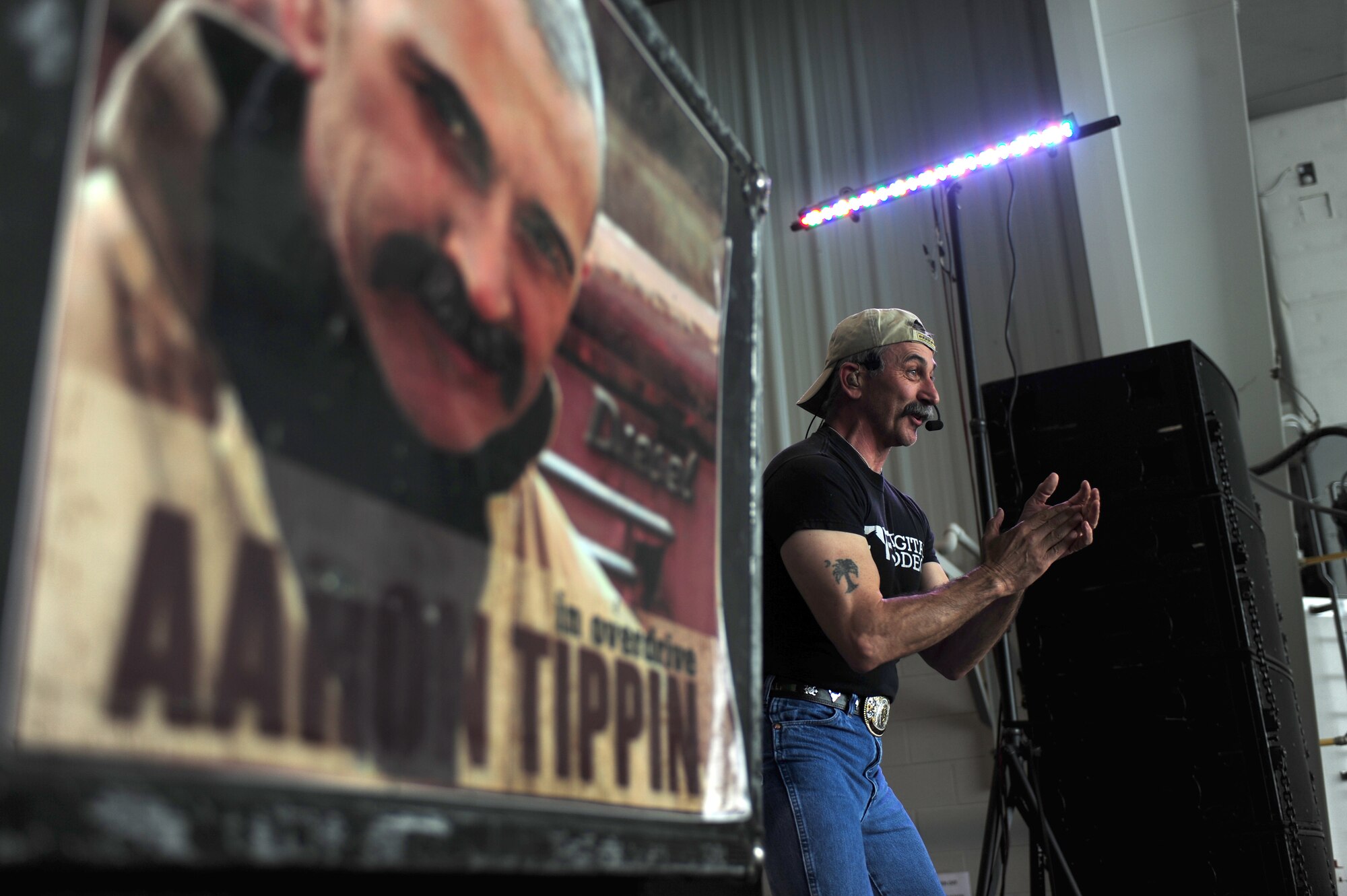 SEYMOUR JOHNSON AIR FORCE BASE, N.C. -- Country music star Aaron Tippin performs "Truck Drivin' Man" during the Wings Over Wayne Air Show and Open House here, April 16, 2011. Tippin built a bicycle to be donated to Toys for Tots during his performance. (U.S. Air Force photo/Senior Airman Rae Perry) (RELEASED)