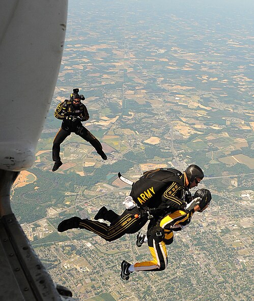 SEYMOUR JOHNSON AIR FORCE BASE, N.C. -- Members of the U.S. Army Golden Knights parachute team perform a tandem jump with News Argus photographer Michael Betts April 15, 2011. The Golden Knights also performed during the Wings Over Wayne Air Show and Open House April 16-17. (U.S. Air Force photo/Senior Airman Gino Reyes) (Released)