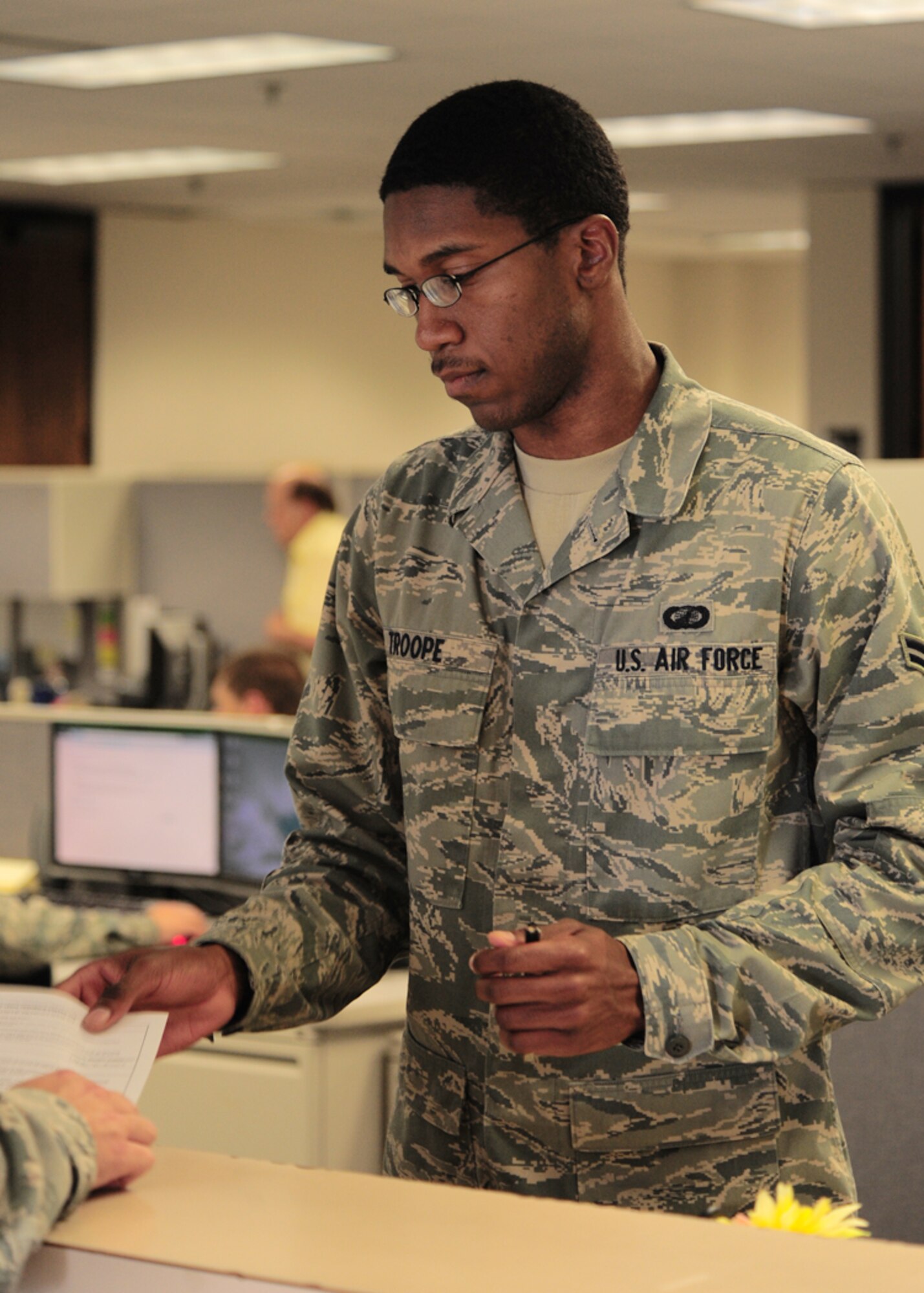 SHAW AIR FORCE BASE, S.C. - Airman 1st Class Terrence Troope, 20th Comptroller Squadron lead defense travel administrator, helps out a customer at the finance office here April 20, 2011.  Airman Troope is the Warrior of the Week for April 18 through 22.  (U.S. Air Force photo/Airman 1st Class Daniel Phelps)(RELEASED)