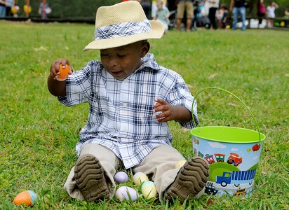 An excited two-year-old Cshammar Reed, looks through his stash of collected eggs after completing an Easter egg hunt during the annual Eggstravaganza event held at Marrington Plantation on Joint Base Charleston-Weapons Station April, 16. The event was sponsored by Morale, Welfare and Recreation in conjunction with the Month of the Military child, and provided a fun-filled day for the whole family. (U.S. Navy photo/Mass Communication Specialist 1st Class Jennifer Hudson)