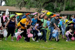 Taking off with parents in tow, children between the ages of one and three rushed to grab scattered eggs during the annual Eggstravaganza event held at Marrington Plantation on Joint Base Charleston-Weapons Station April 16. Although severe thunderstorms threatened the skies early Saturday morning, the event hosted by Morale, Welfare and Recreation was a success and provided free fun the whole family. (U.S. Navy photo/Mass Communication Specialist 1st Class Jennifer Hudson)