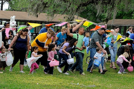 Taking off with parents in tow, children between the ages of one and three rushed to grab scattered eggs during the annual Eggstravaganza event held at Marrington Plantation on Joint Base Charleston-Weapons Station April 16. Although severe thunderstorms threatened the skies early Saturday morning, the event hosted by Morale, Welfare and Recreation was a success and provided free fun the whole family. (U.S. Navy photo/Mass Communication Specialist 1st Class Jennifer Hudson)