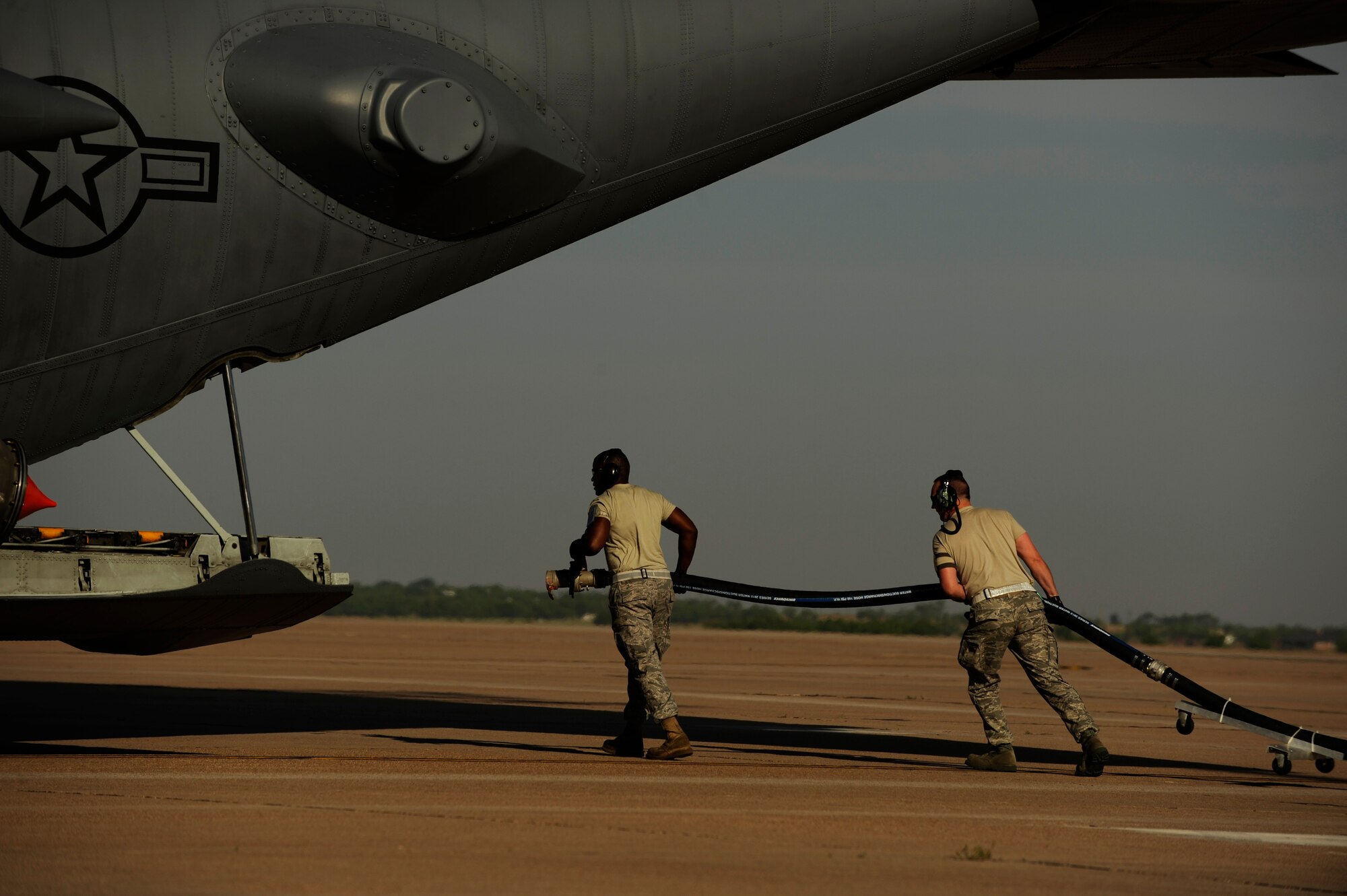 Airmen from California Air National Guard's 146th Airlift Wing, North Carolina Air National Guard's 145th Airlift Wing and Wyoming Air National Guard's 153rd Airlift Wing prepare to fill a C-130H Hercules equipped with the Modular Airborne Firefighting System(MAFFS) with fire retardant at Dyess Air Force Base, Texas, April 19, 2011.  MAFFS is capable of dispensing 3,000 gallons of water or fire retardant in under 5 seconds.  The fire retardant has fertilizer in it to promote new growth after the fires have been put out.  (U.S. Air Force Photo/Staff Sgt. Eric Harris)