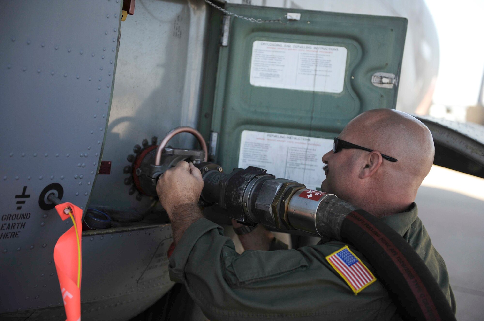 Master Sgt. Chuck Watkins connects a fuel hose to a C-130 Hercules, while preparing the aircraft for wildfire fighting operations across Texas April 18, 2011, at Dyess Air Force Base, Texas. The C-130 is equipped with the Modular Airborne Firefighting System, which is capable of dispensing 3,000 gallons of water or fire retardant in less than 5 seconds. Sergeant Watkins is assigned to the California Air National Guard's 115th Airlift Squadron. (U.S. Air Force photo/Staff Sgt. Eric Harris)