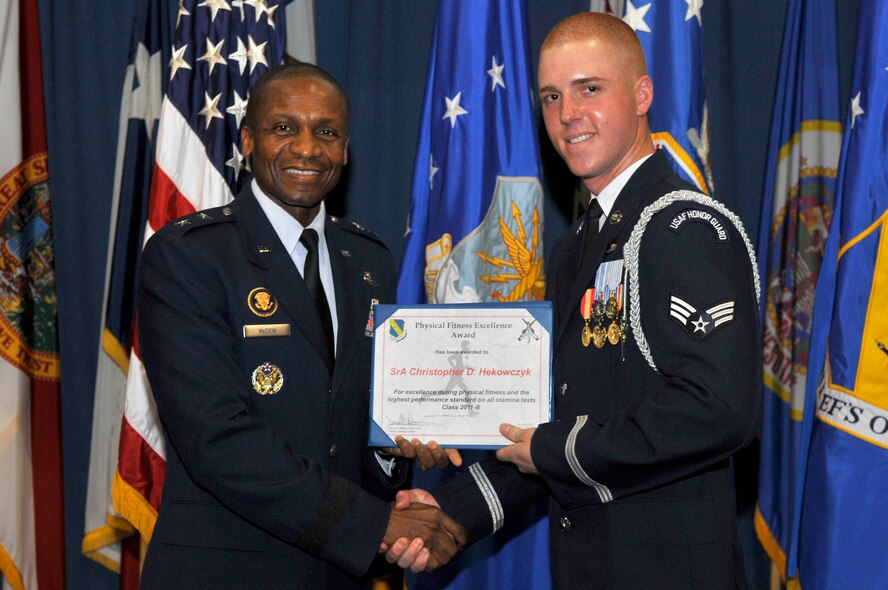 Maj. Gen. Darren McDew, Air Force District of Washington commander, presents the Physical Fitness Excellence Award to Senior Airman Christopher D. Hekowczyk of The U.S. Air Force Honor Guard's graduating class 2011-B, April 8, in the Honor Guard's Ceremonial Hall on Joint Base Anacostia-Bolling, Washington D.C. The graduates were recognized for their outstanding achievements during the eight week technical training school which qualifies Airmen to be part of the Air Force's elite ceremonial honor guard. (U.S. Air Force photo by Senior Airman Steele C. G. Britton)